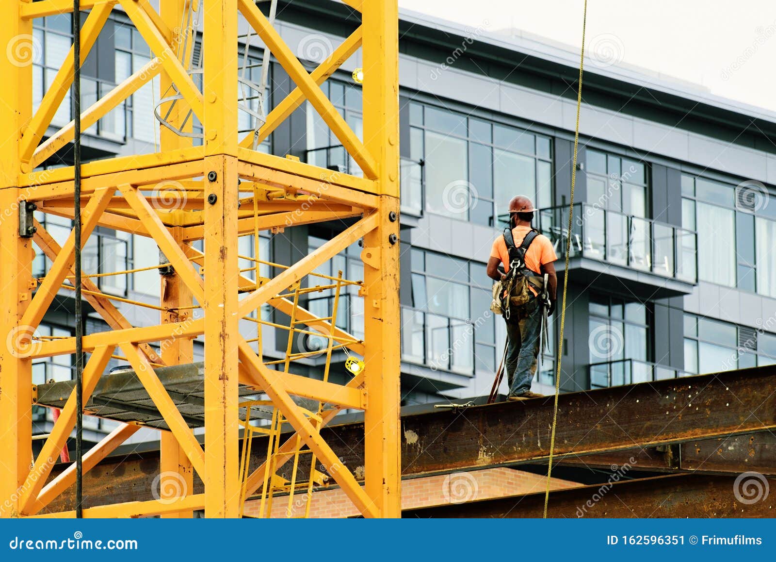 Construction Worker Wearing Safety Harnesses and Safety Line Working