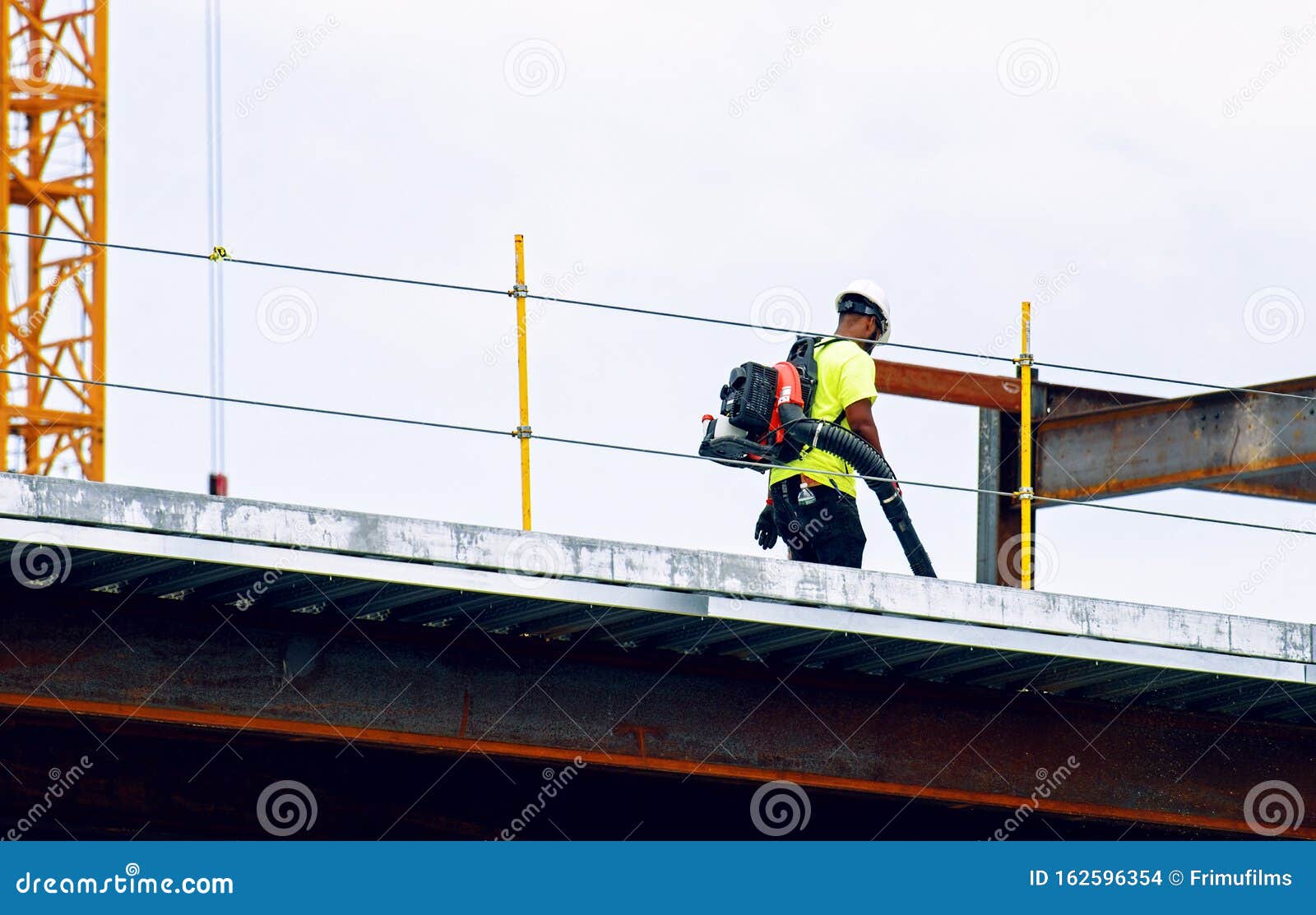 Construction Worker Working on the Site with a Vacuum Cleaner Editorial