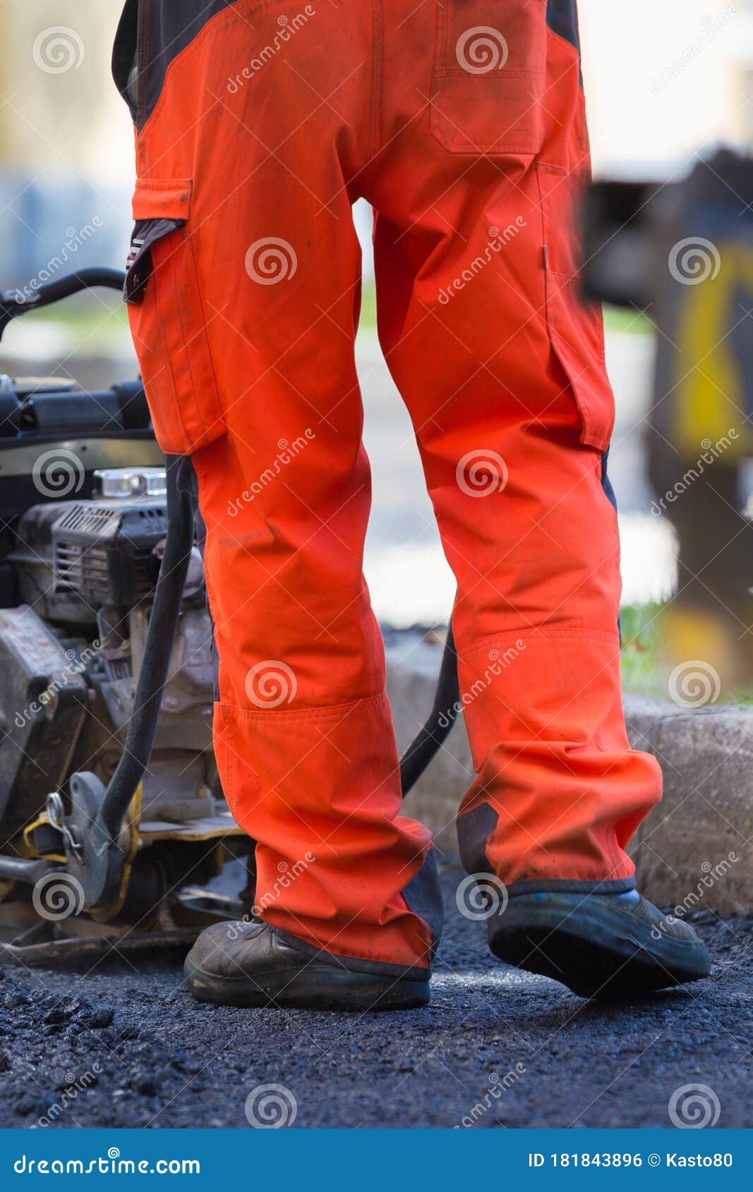Construction Workers during Asphalting Road Works Wearing Coveralls