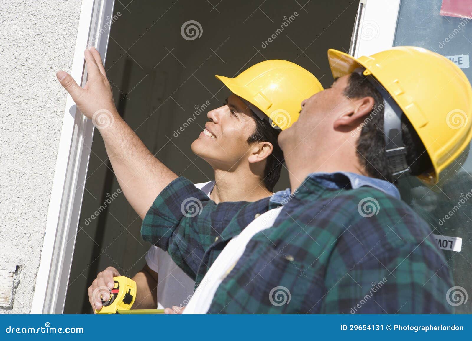 construction workers checking window