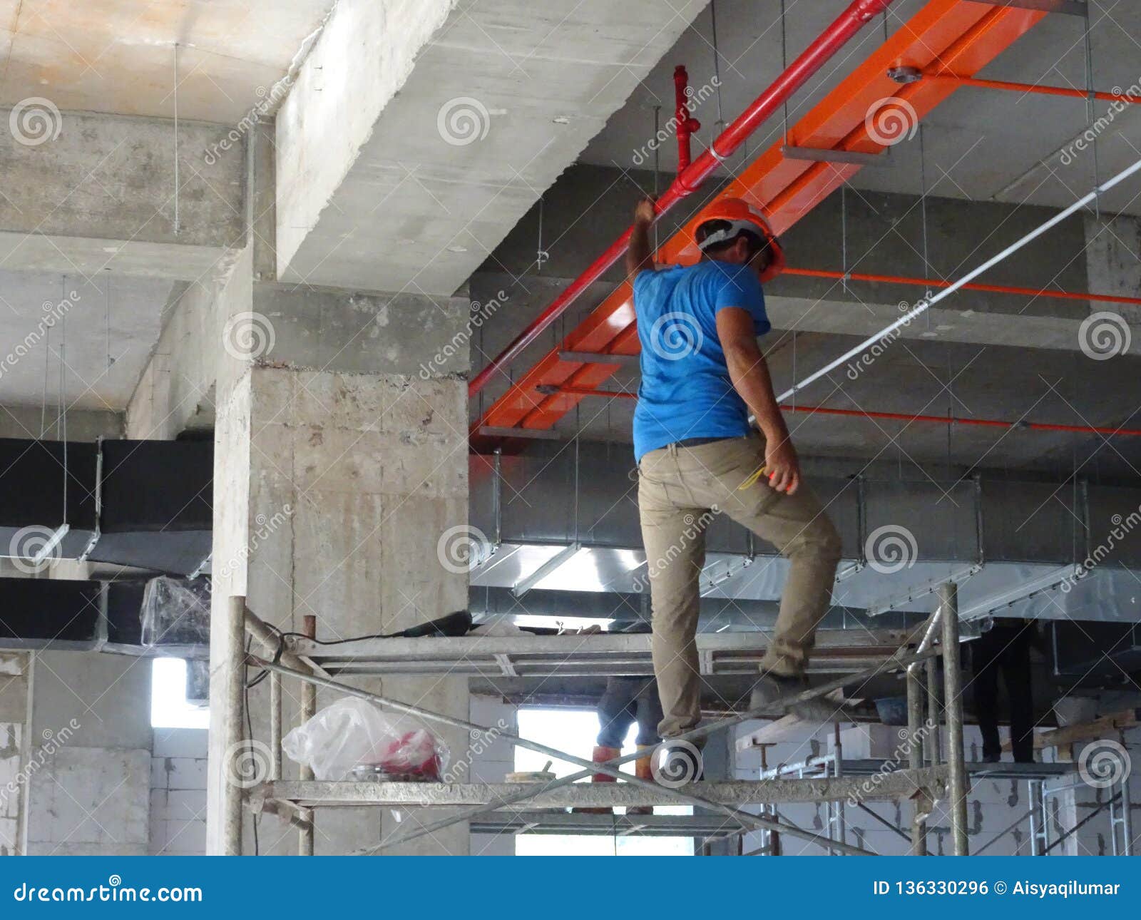 Construction Workers Installing Electrical Cable Tray On The Floor