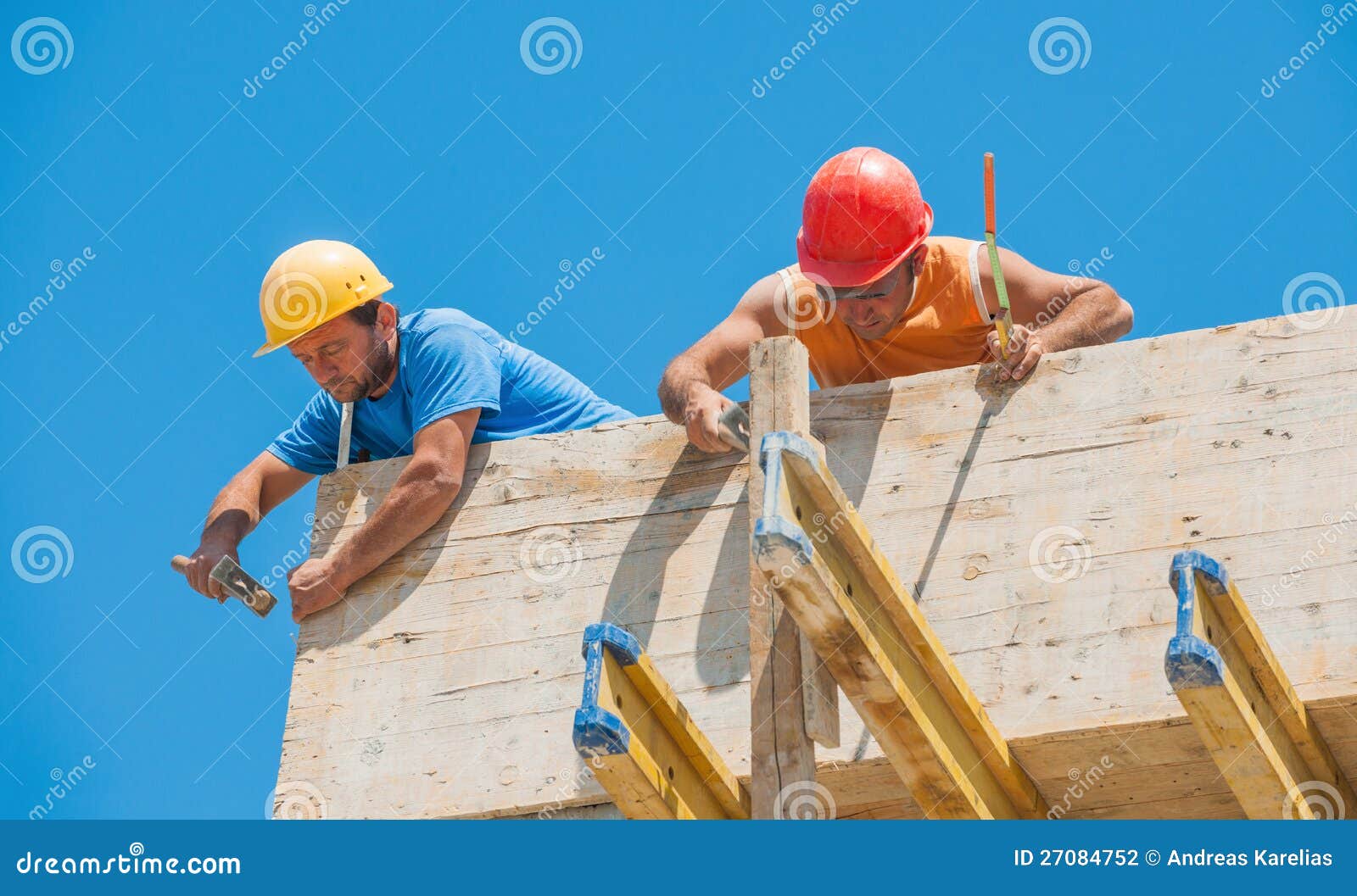 construction workers nailing formwork in place