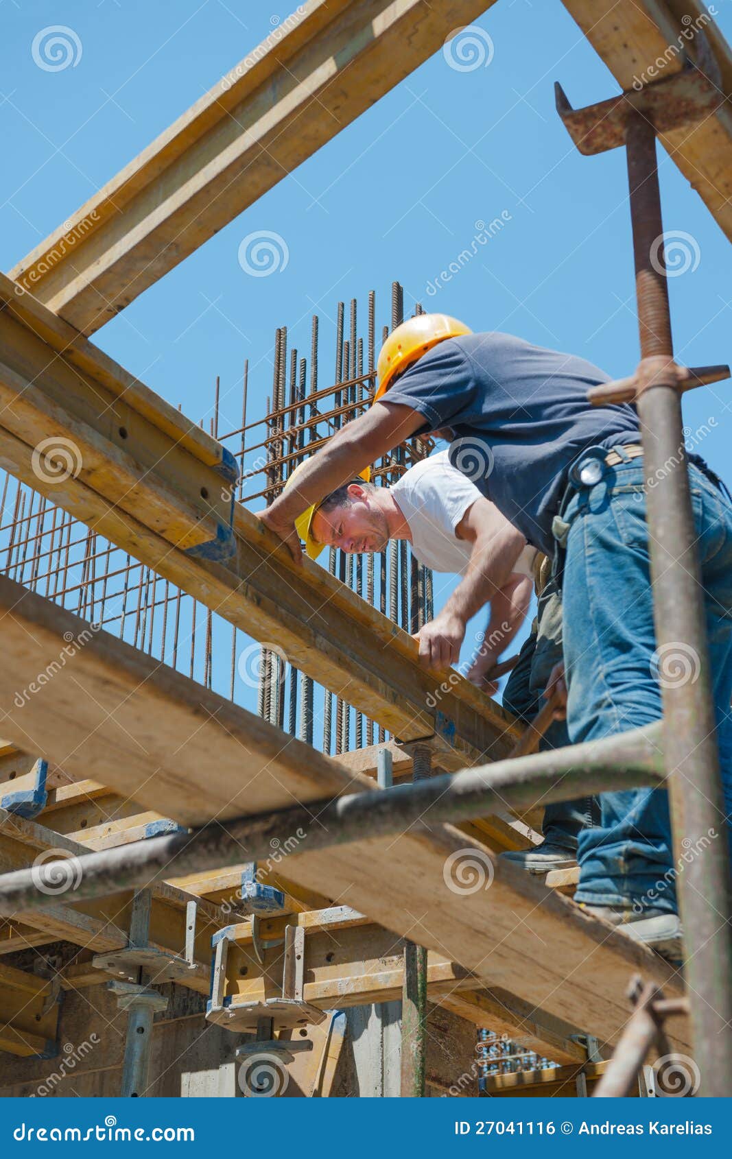 construction workers placing formwork beams