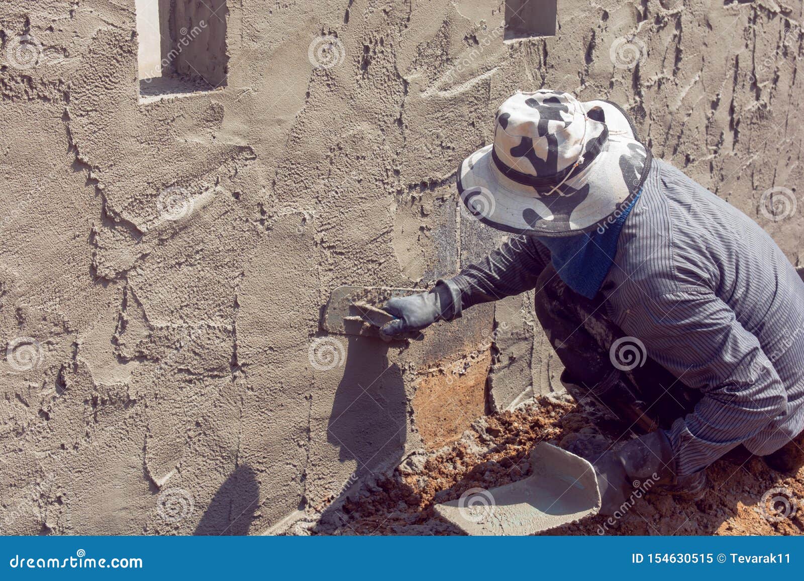 Construction Workers Plastering Building Wall Using Cement Plaster