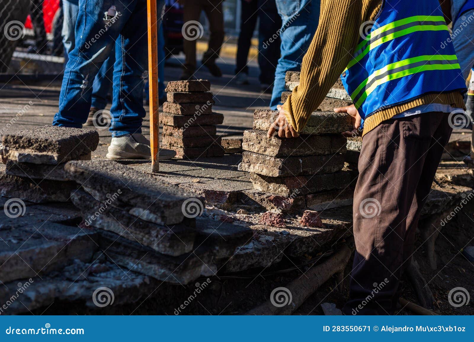 construction workers remove cement from a recreational park that will be redeveloped