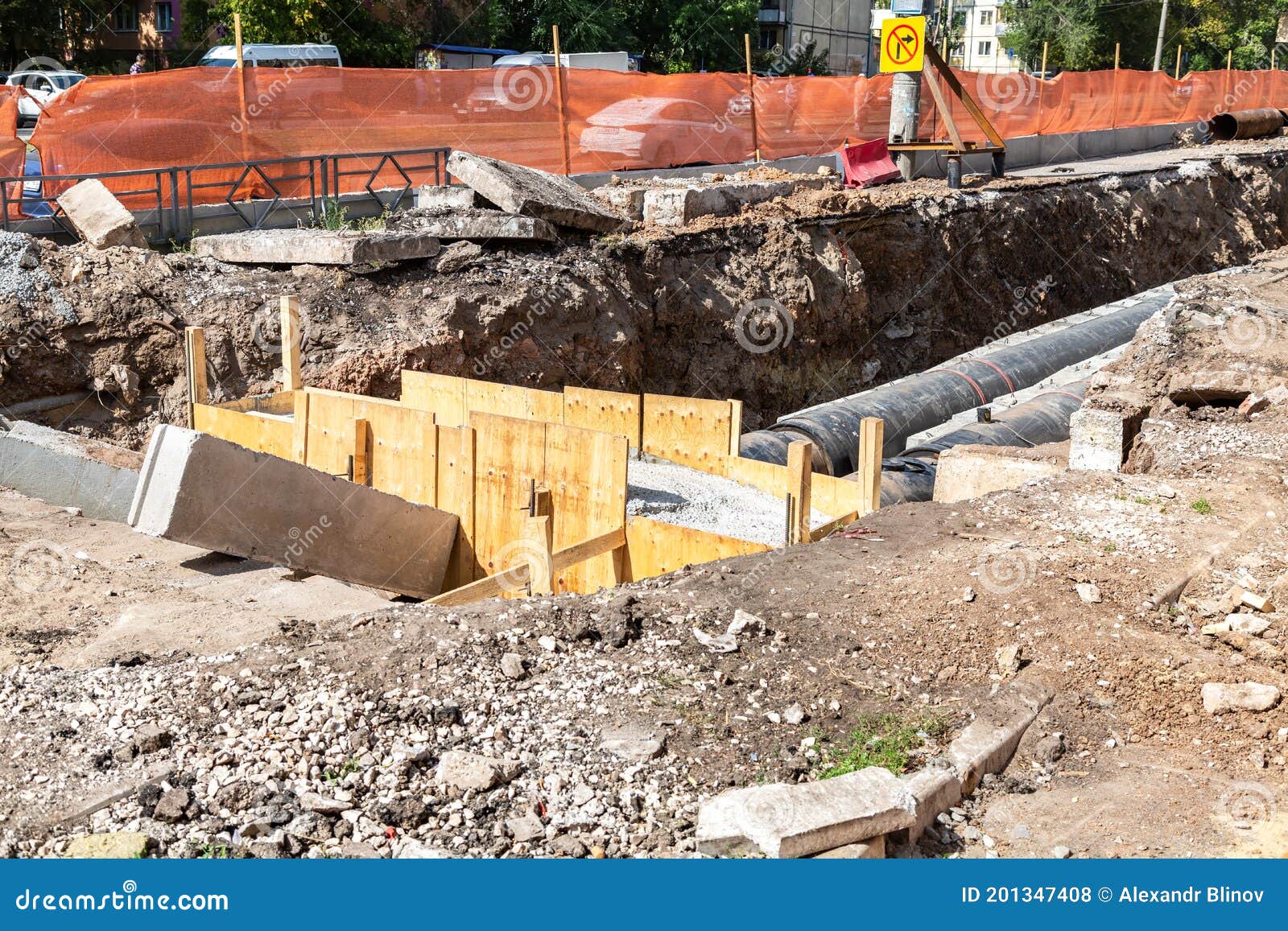 Construction Works on Large Iron Pipes at a Depth of Excavated Trench ...