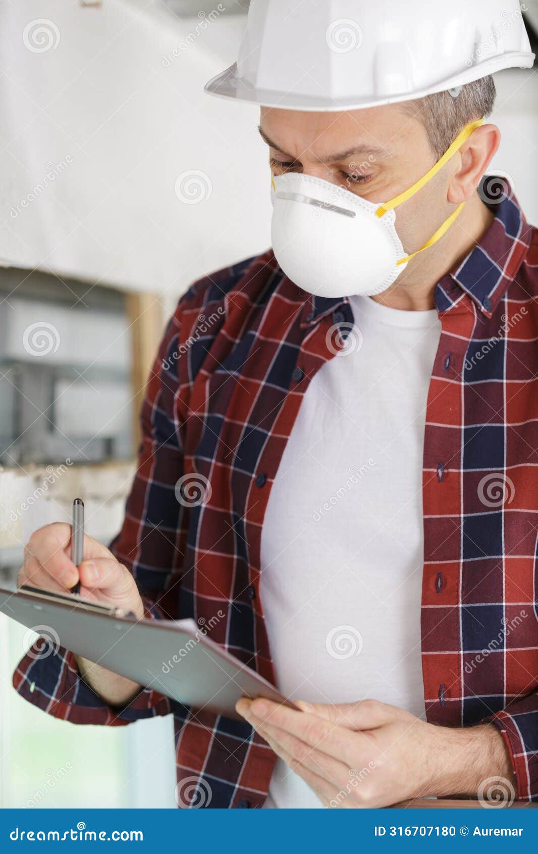 Constructor Looking on Blue Clipboard Stock Photo Image of smile
