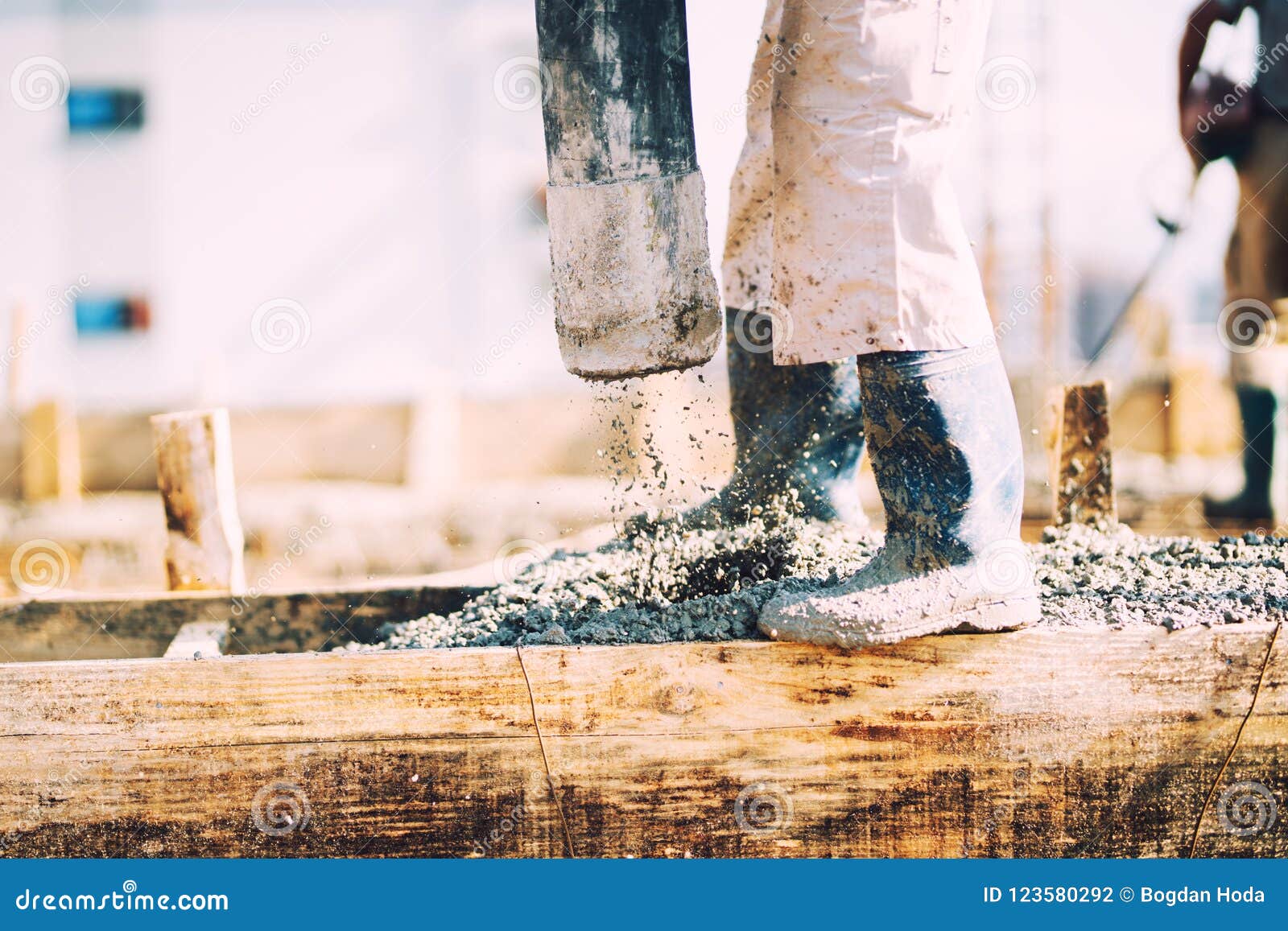 constuction details - worker laying cement or concrete with automatic pump