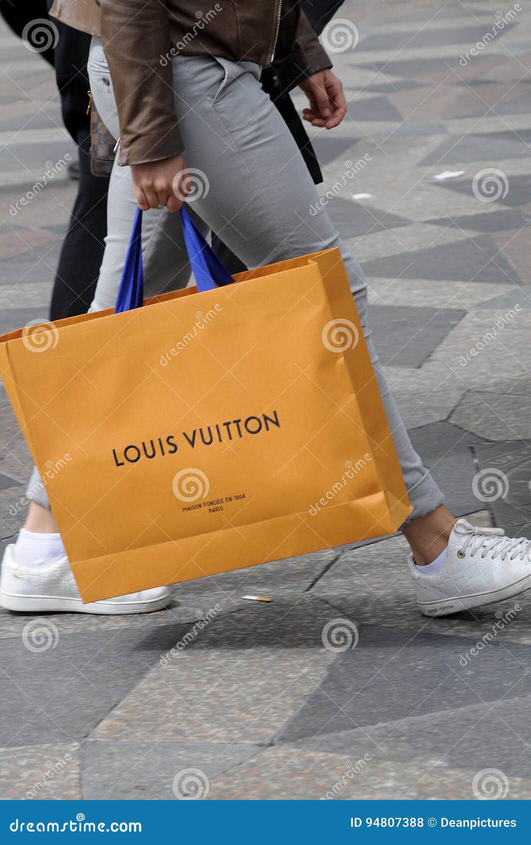 CONSUMERS with LOUIS VUITTON SHOPPING BAG Editorial Stock Photo