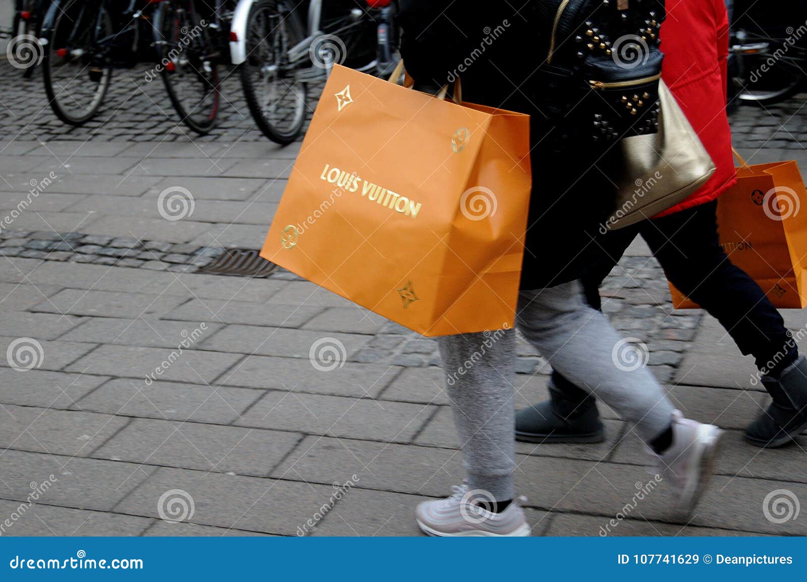 CONSUMERS WITH LOUIS VUITTON SHOPPING BAGS Editorial Stock Image - Image of shopping, finance ...
