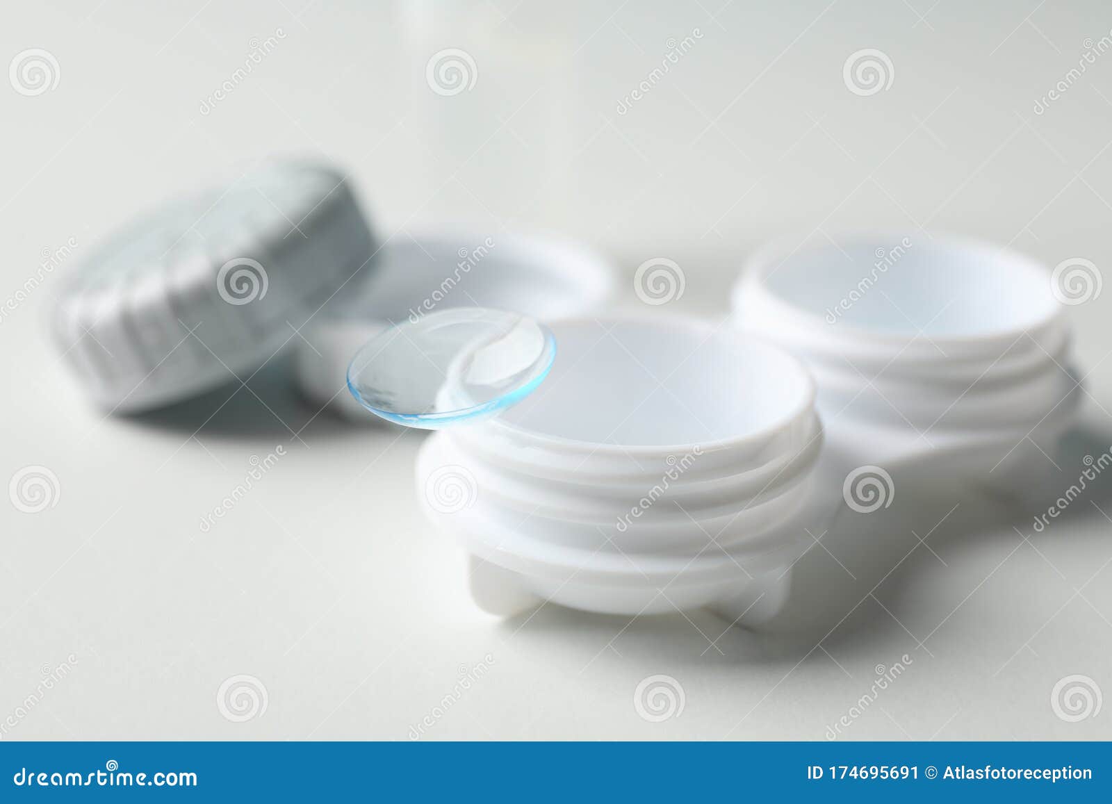 contact lenses and case on white background