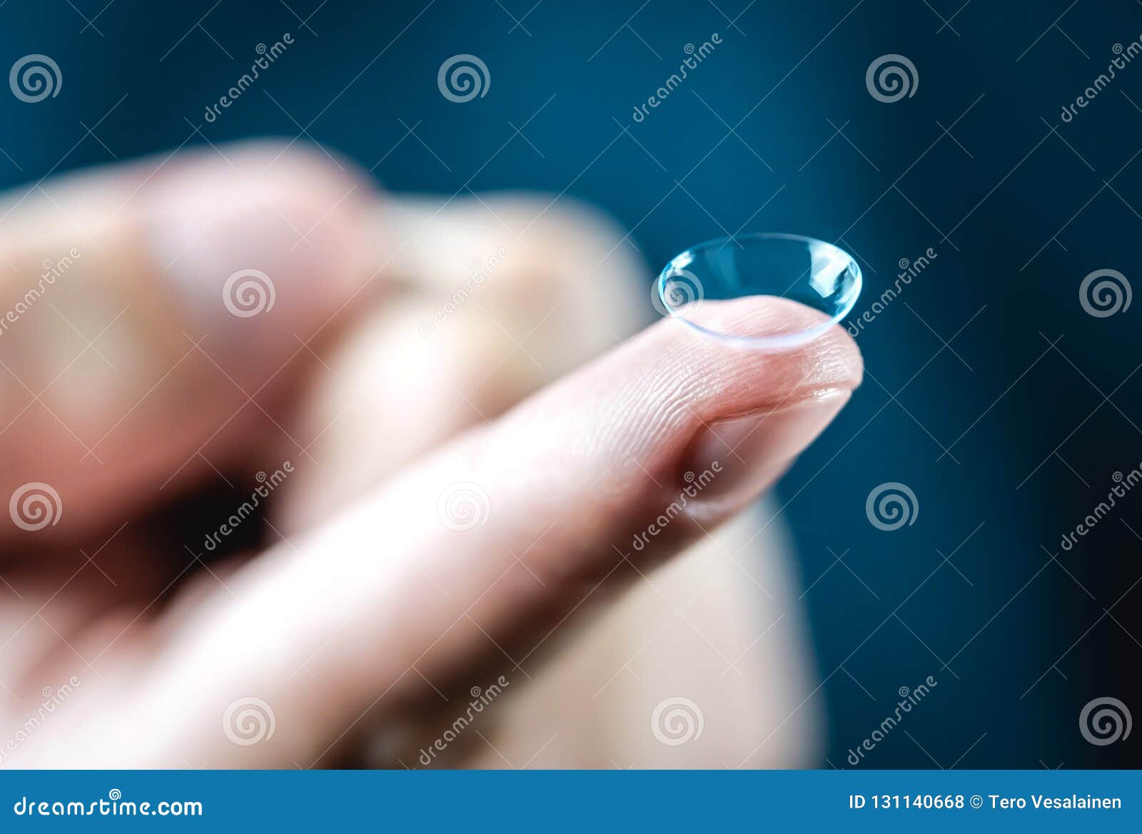 contact lenses macro close up. man holding lens on finger.