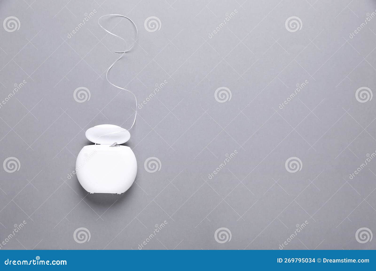 Container with Dental Floss on Grey Background, Top View. Space for