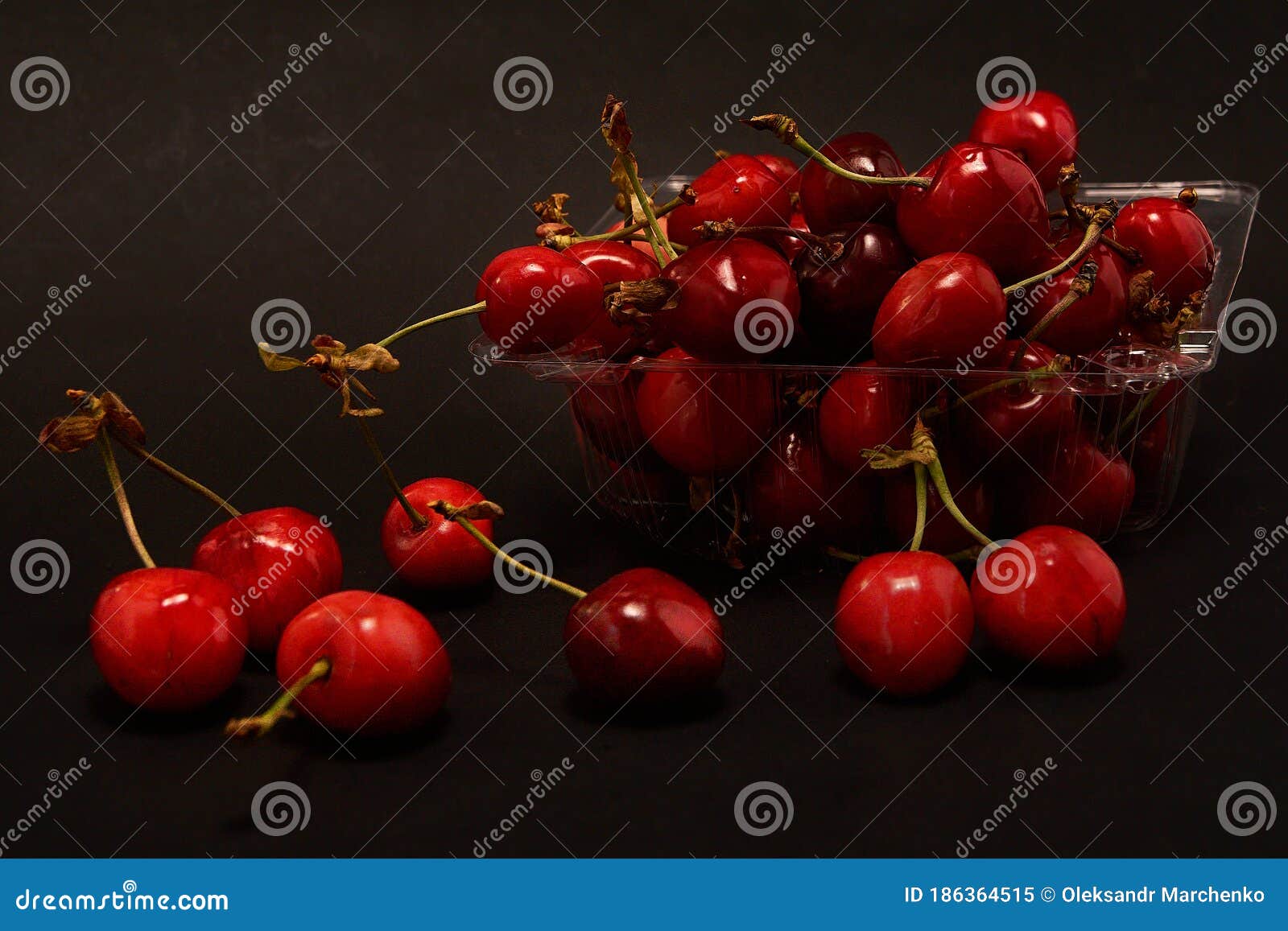 Container of Fresh Cherries on a Black Background. Stock Image Image