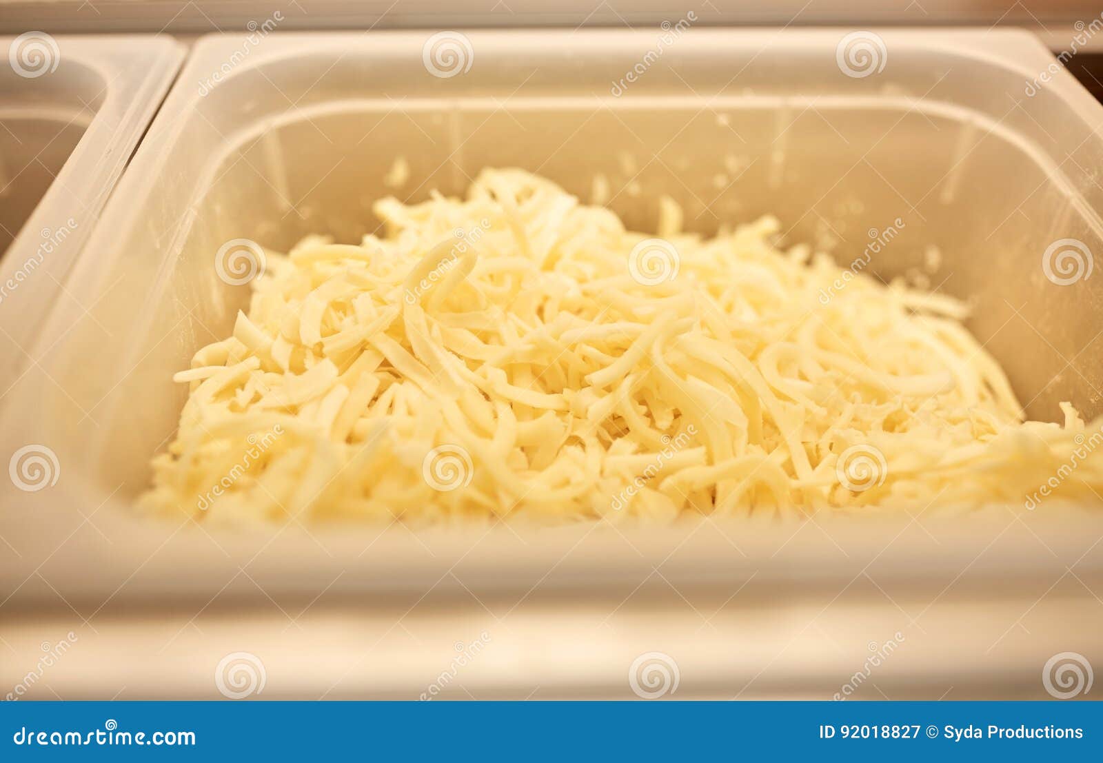 Container with Grated Cheese at Restaurant Kitchen Stock Image