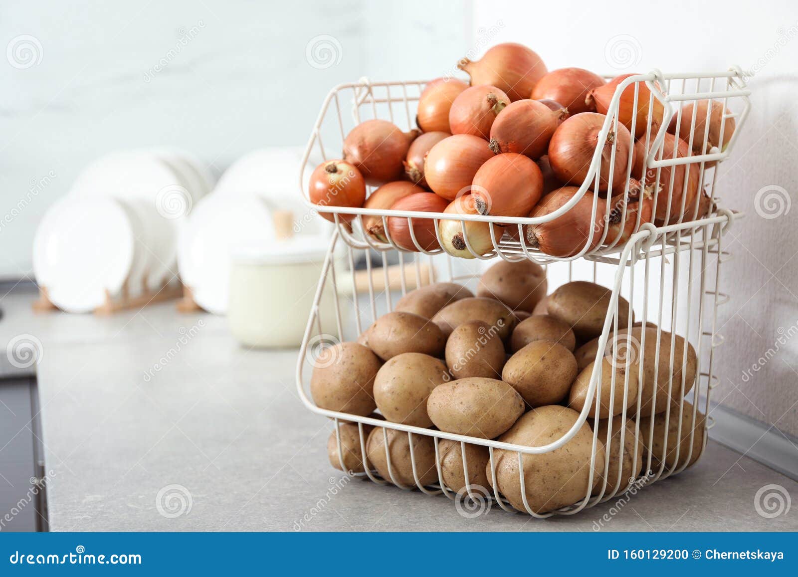 Container with Potatoes and Onions on Kitchen Counter, Space for Text