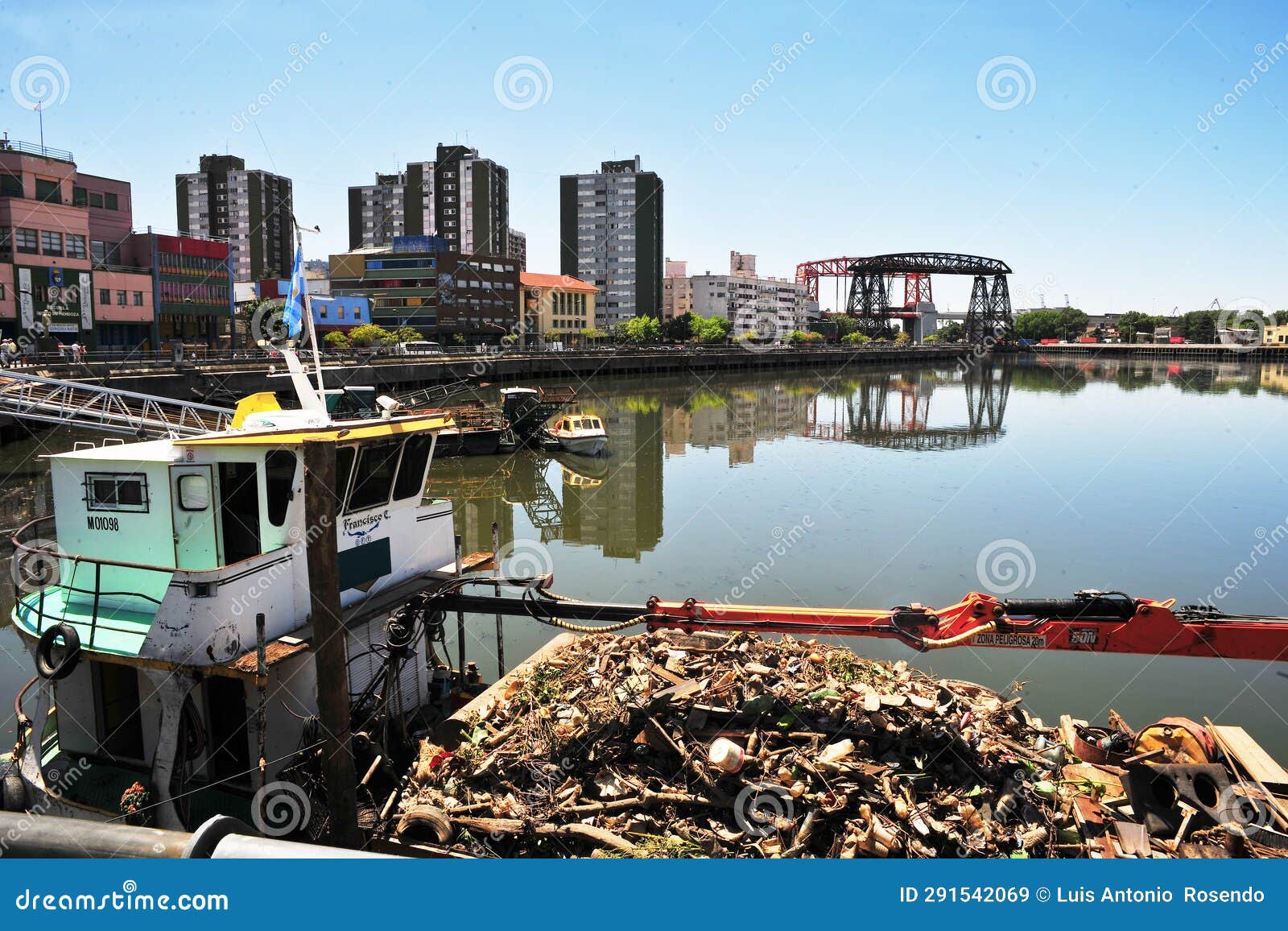 contaminated river full of garbage, riachuelo river. old boat and dirty water arround