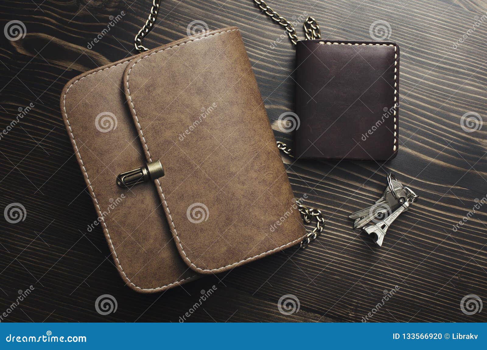 Contents of woman`s bag on wooden background