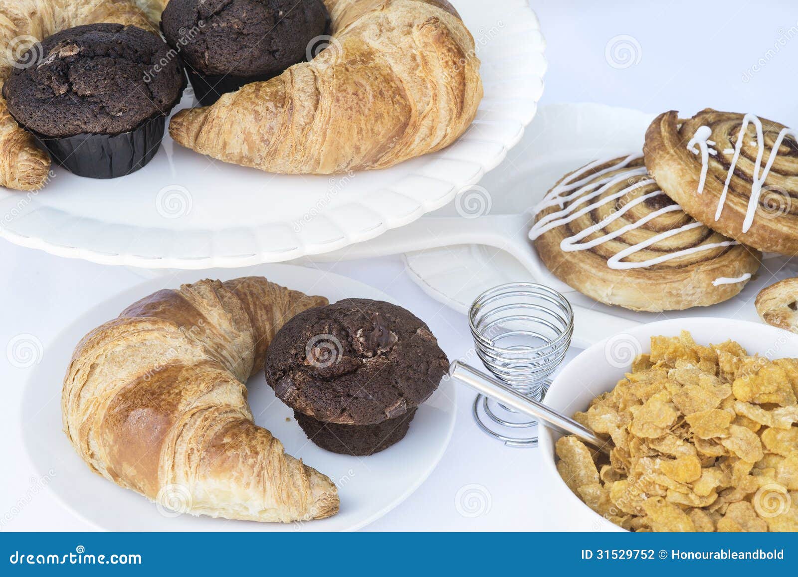 Continental Breakfast Table Setting with Pastries and Cakes Stock Photo