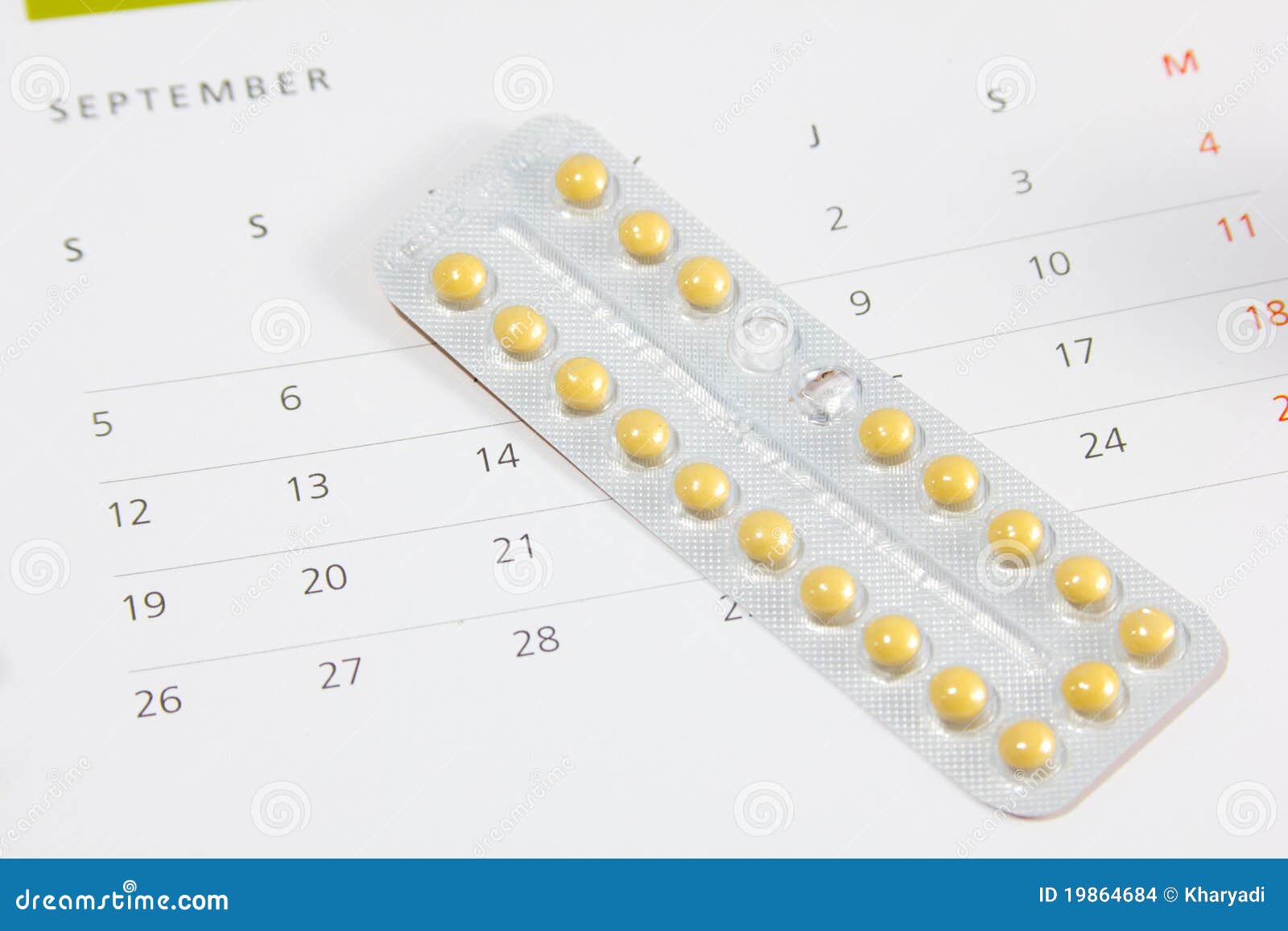 contraceptive pills on a calendar.