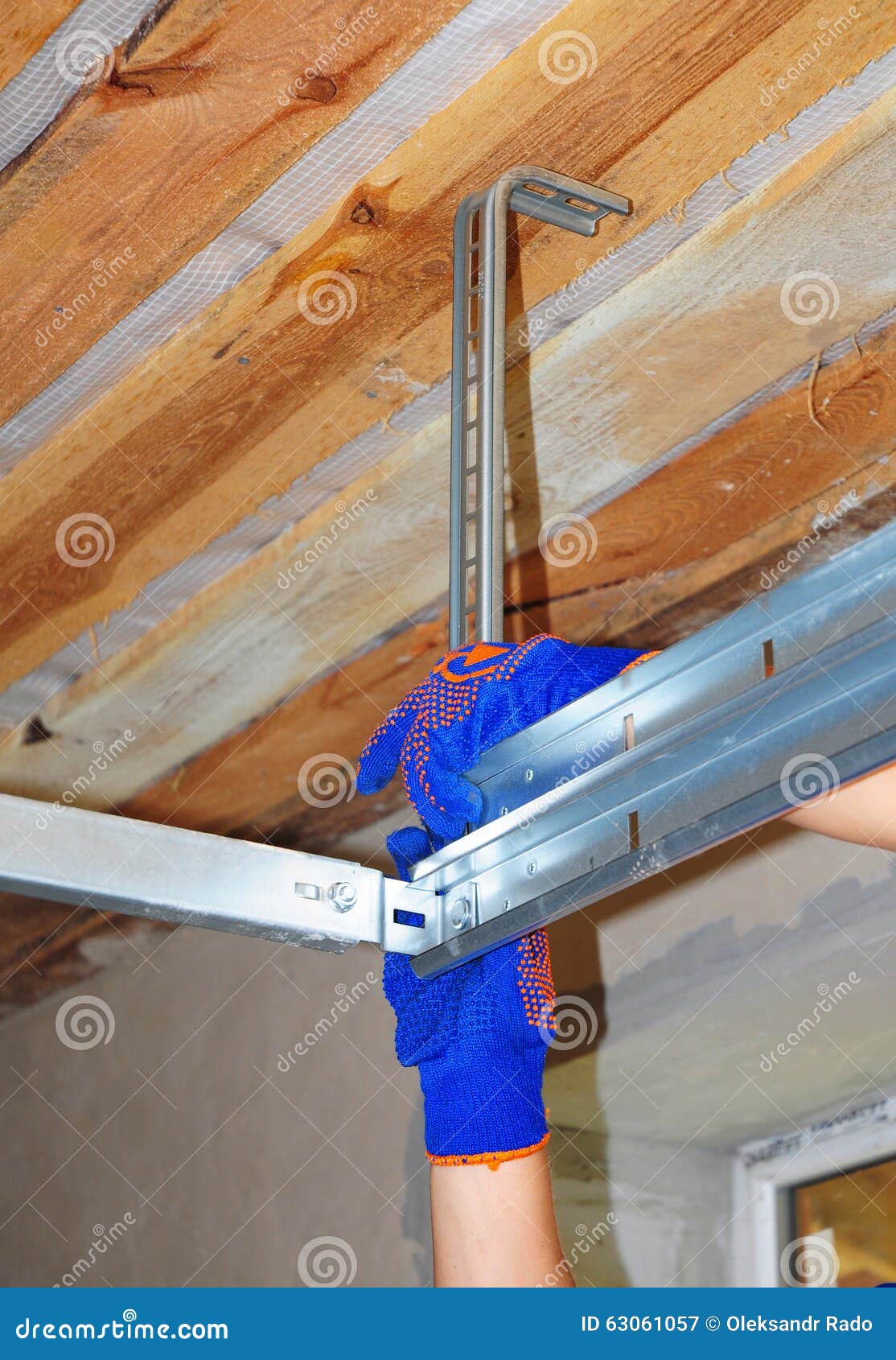 Contractor Installing Garage Door Metal Profil Post Rail And