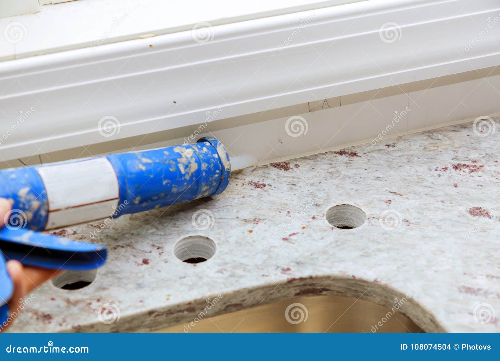 Contractor Installing A Remodeling Home With Granite Counter Tops