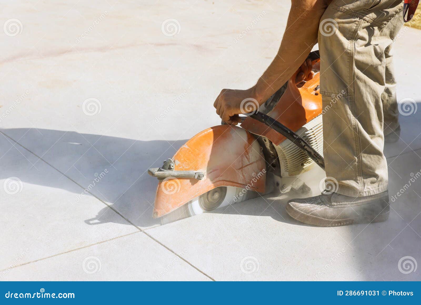 Contractor Utilizes Diamond Blade Saw To Cut Concrete Paving Sidewalk