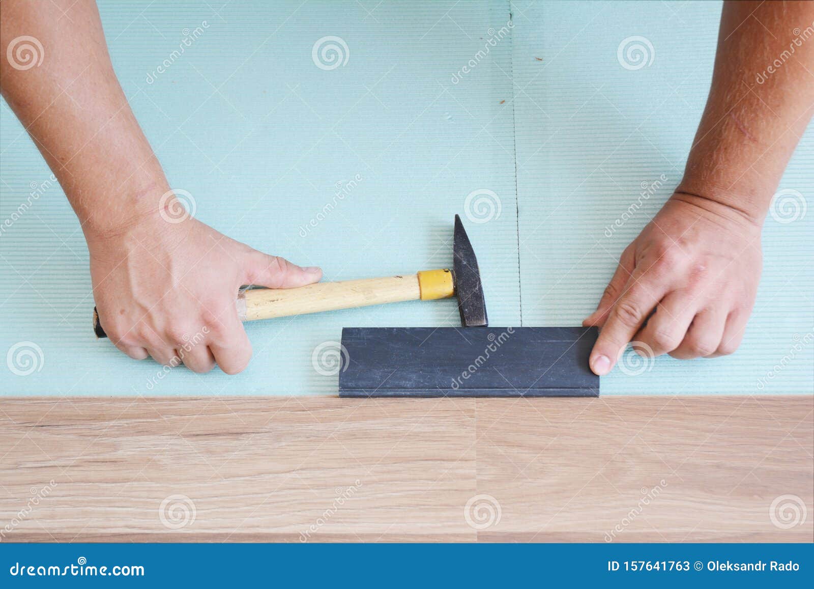 Contractors Installing Wooden Laminate Flooring With Insulation