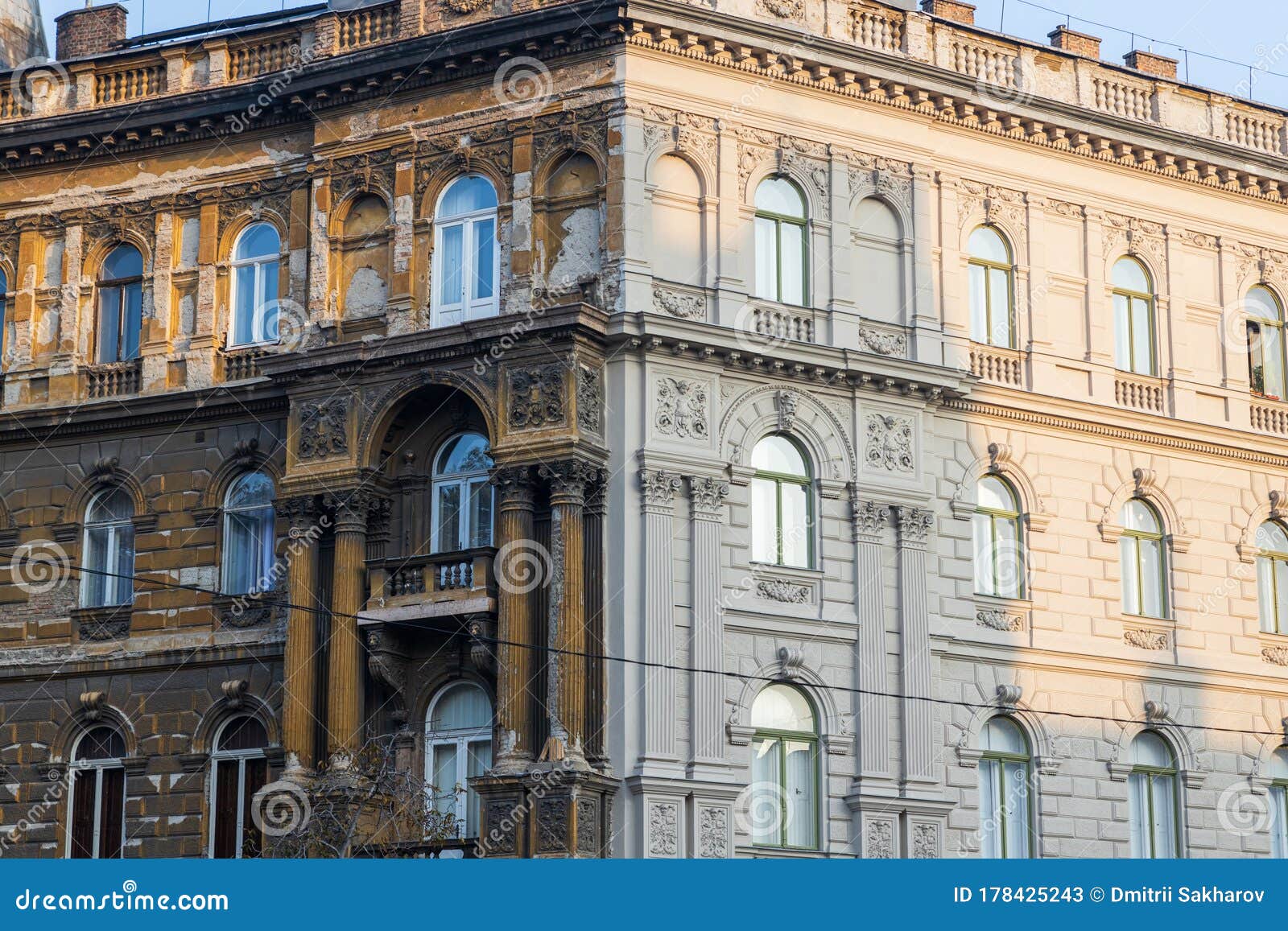 contrast on the building in budapest - one part of the house is renewed
