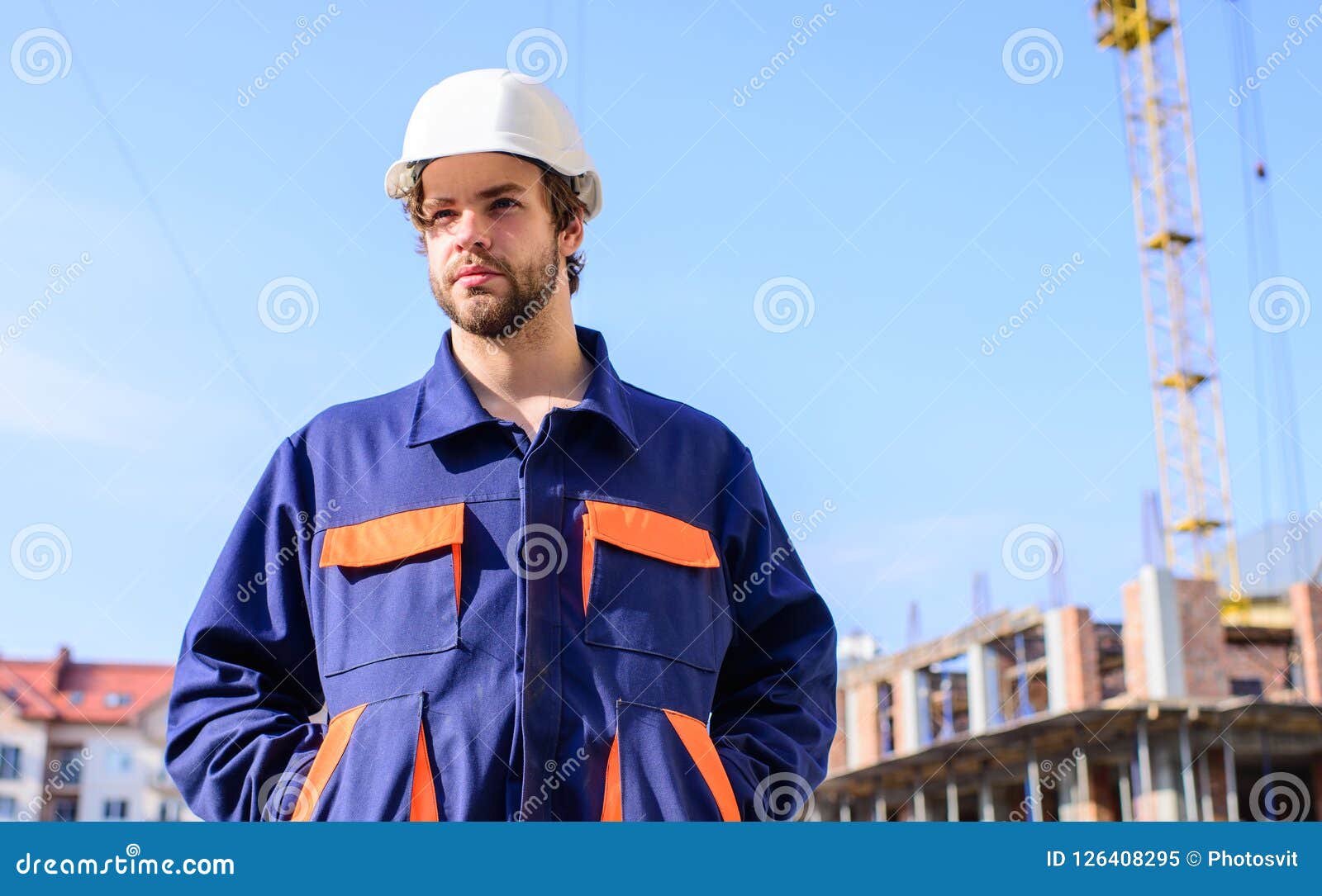 Control Construction Process. Builder in Working Clothes and Helmet