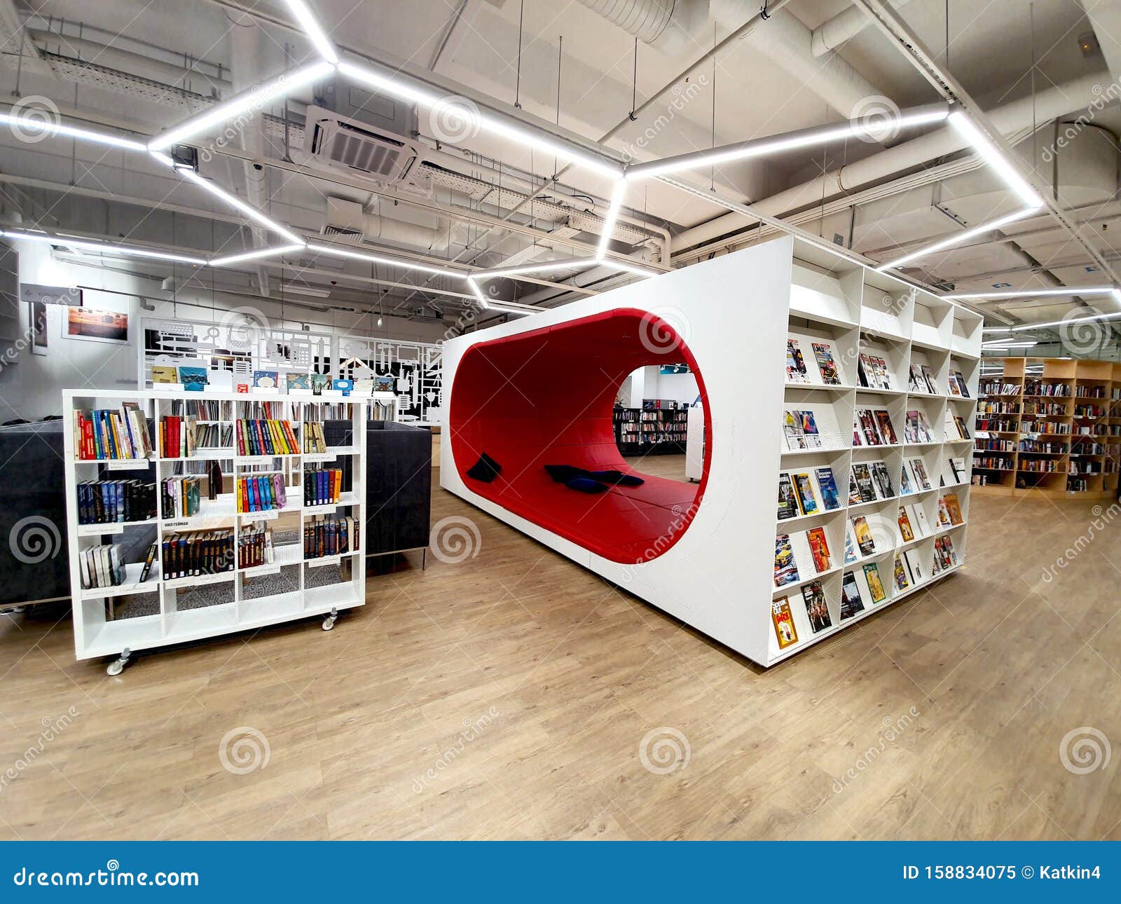 Convenient Modern Library with a Comfortable Red Sofa for Reading