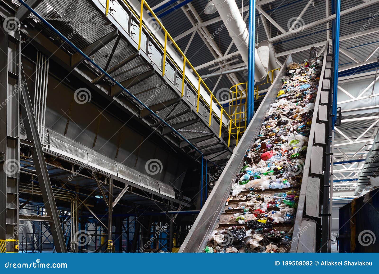 conveyor belt with garbage transports waste inside drum filter or rotating cylindrical sieve with trommel for sorting
