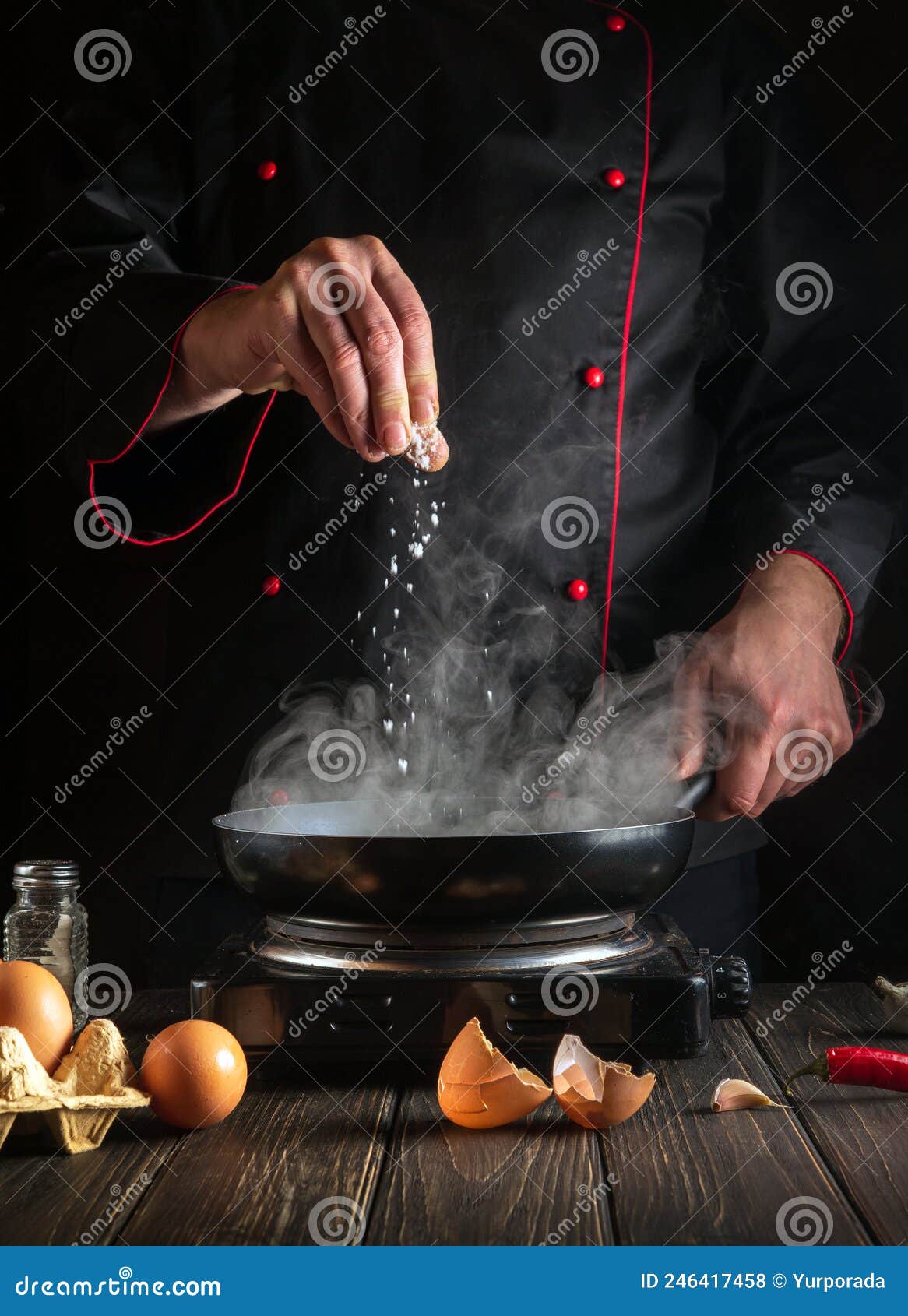 The Cook Adds Salt while Cooking Eggs in Pan. Work Environment on