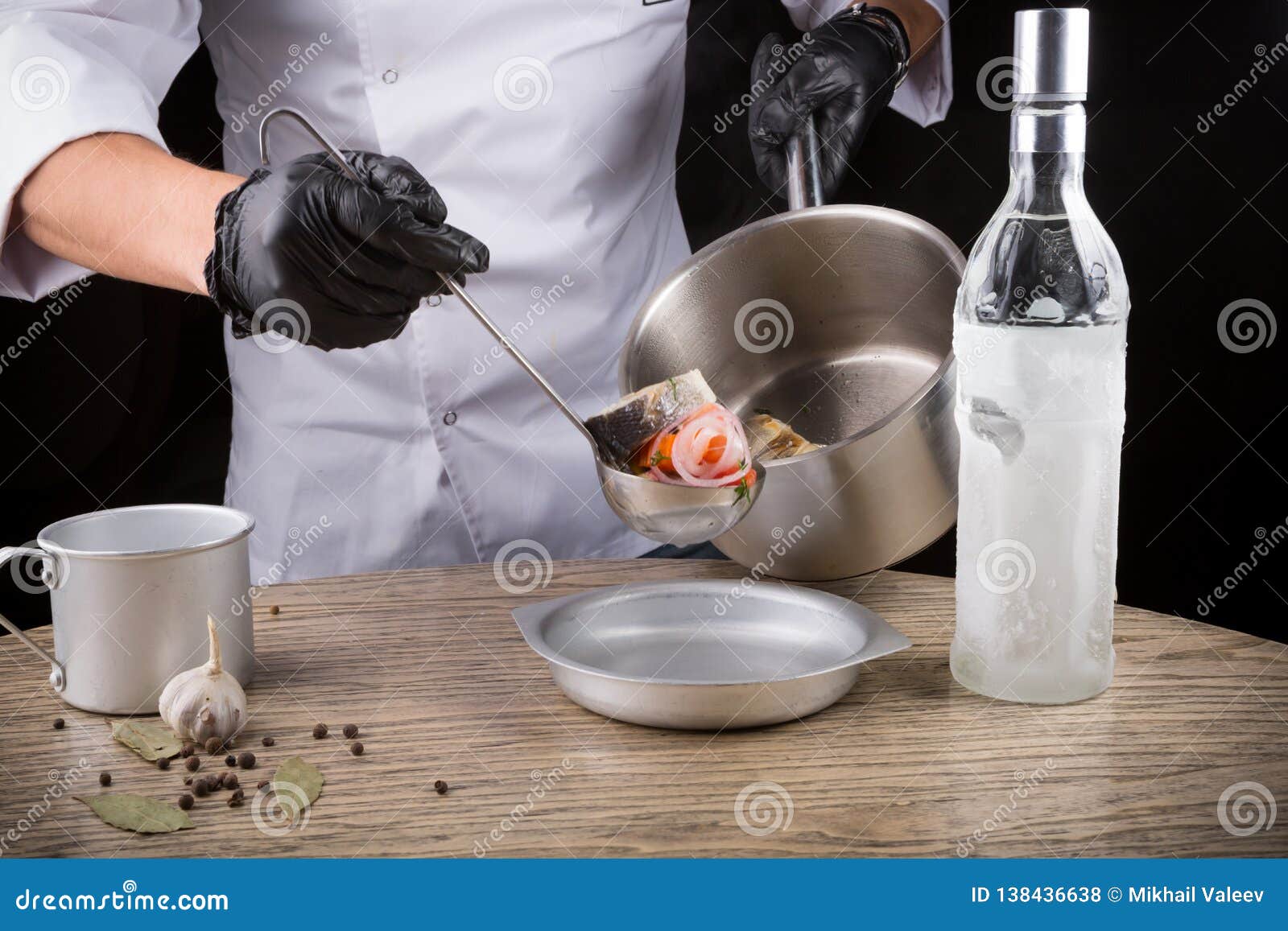 Cook in Black Gloves is Serving Fish Soup Stock Photo Image of