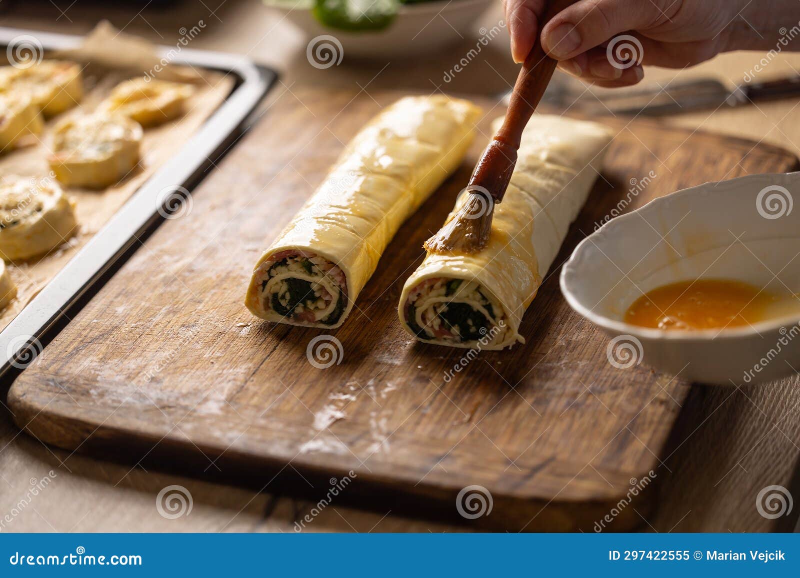 The Cook Brushes an Egg Onto a Puff Pastry Roll Stock Image Image of
