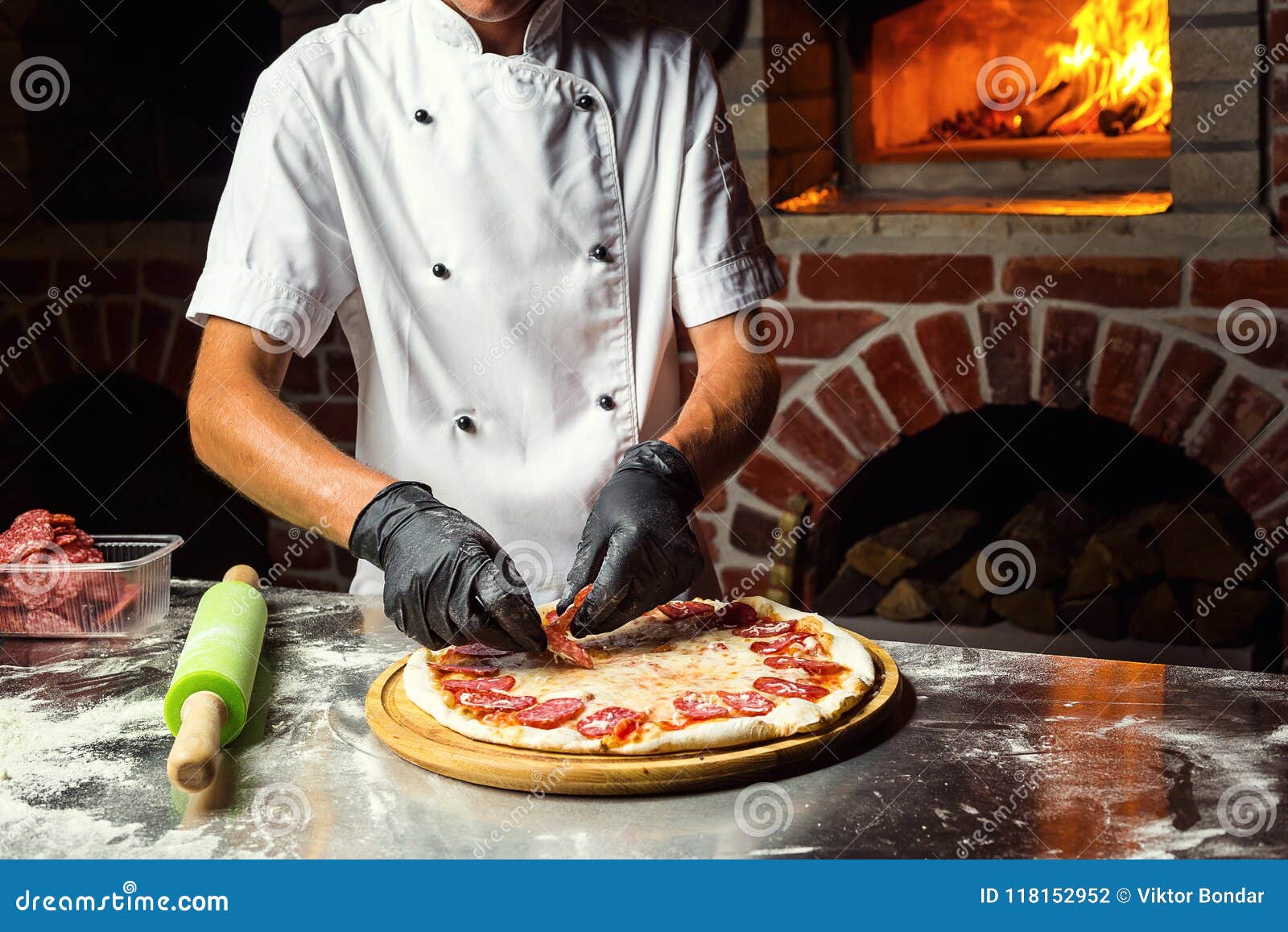Cook Chef Making Delicious Pizza at the Restaurant, Closeup Stock