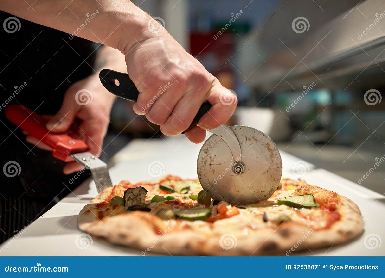 Cook Cutting Pizza To Pieces at Pizzeria Stock Image - Image of cutter ...