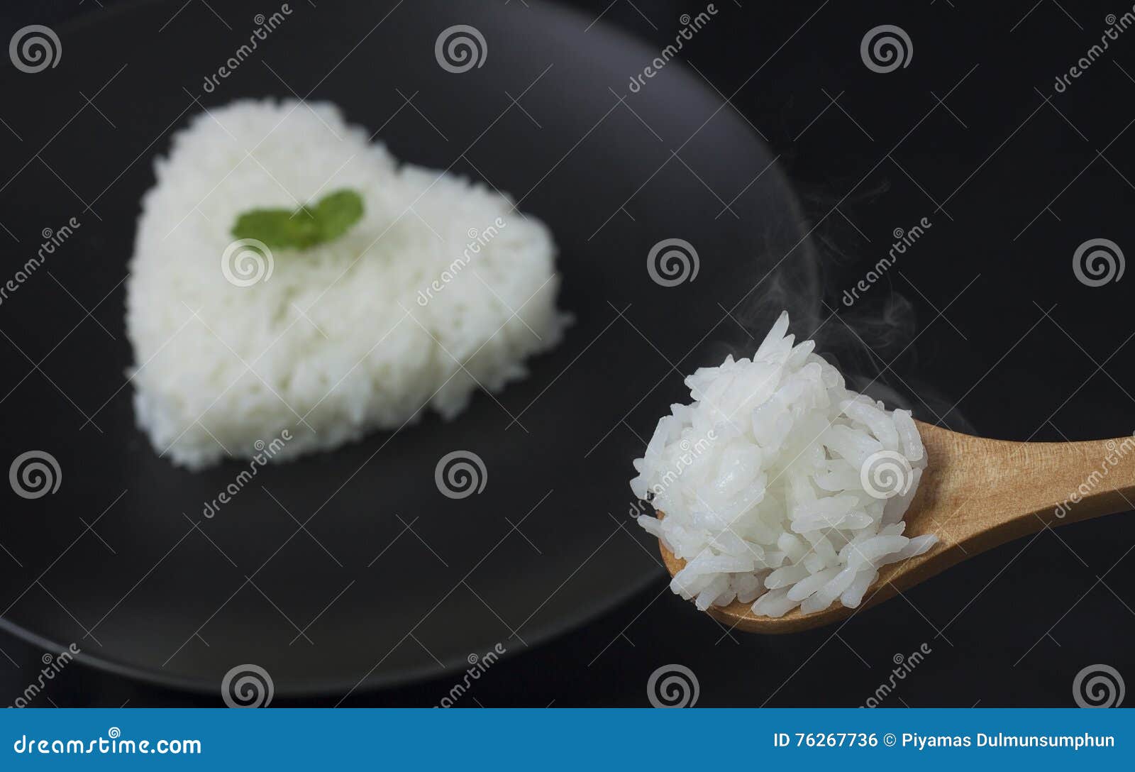 Cook Rice Serve with Heart Shape on Black Dish with Smoke Stock Photo