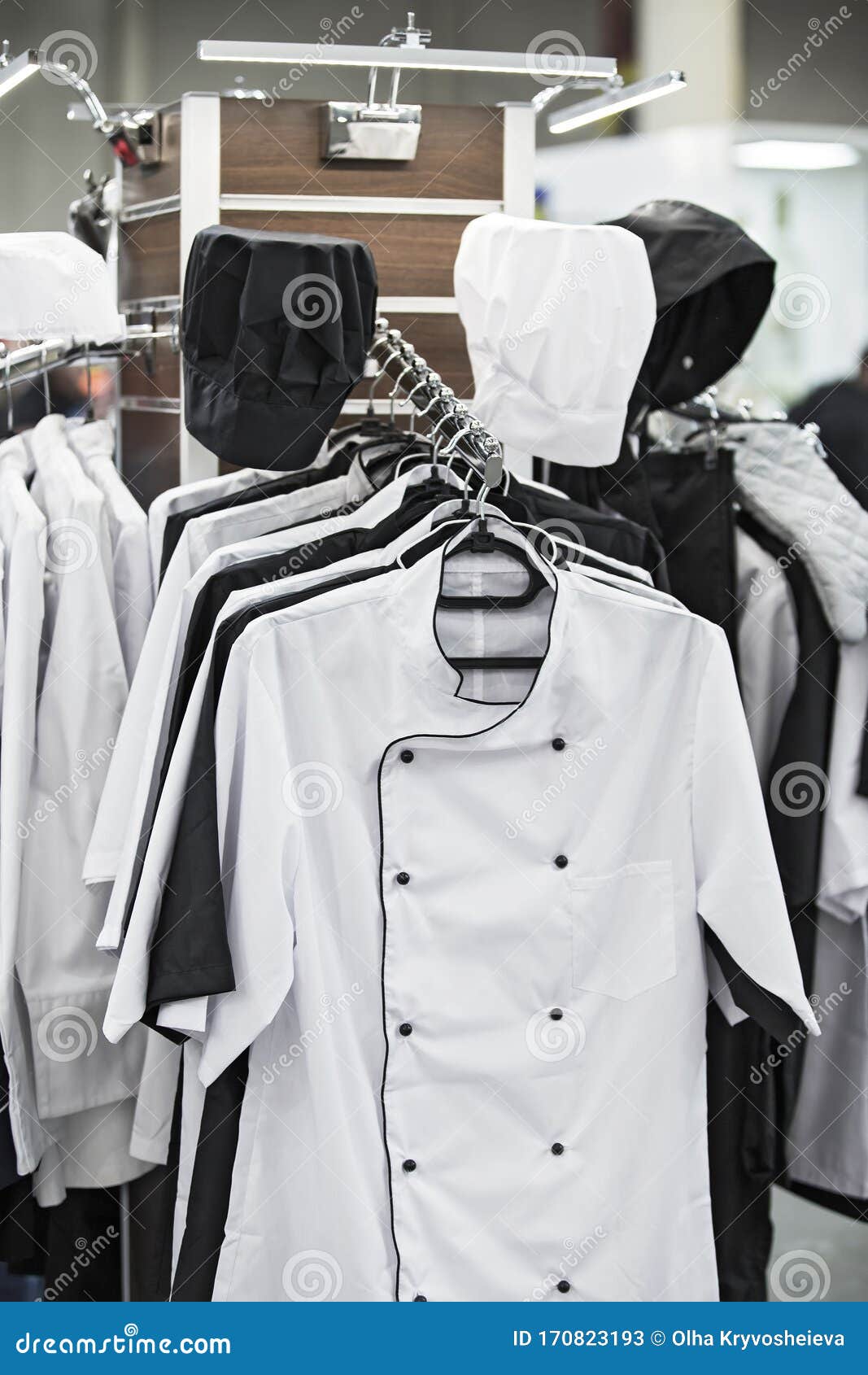 cook uniform in a restaurant on a hanger, white and black uniforms, shirts and hats