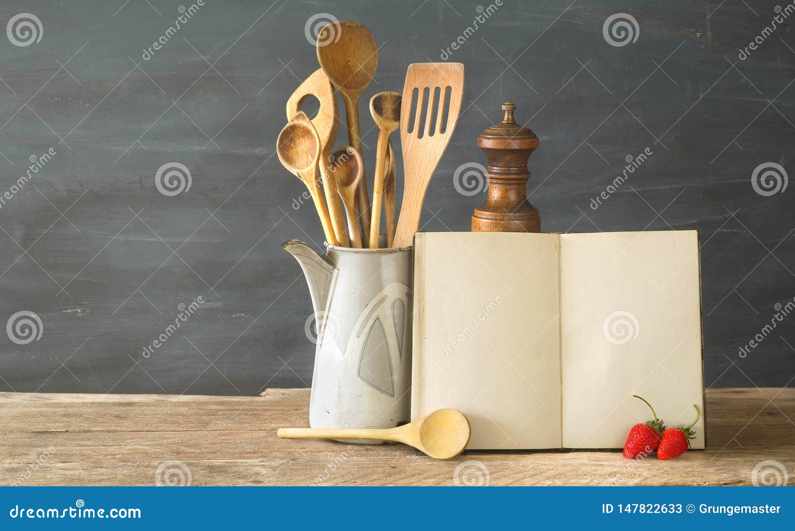 cookbook or recipe book with wooden spoons and strawberries, mockup w. free copy space