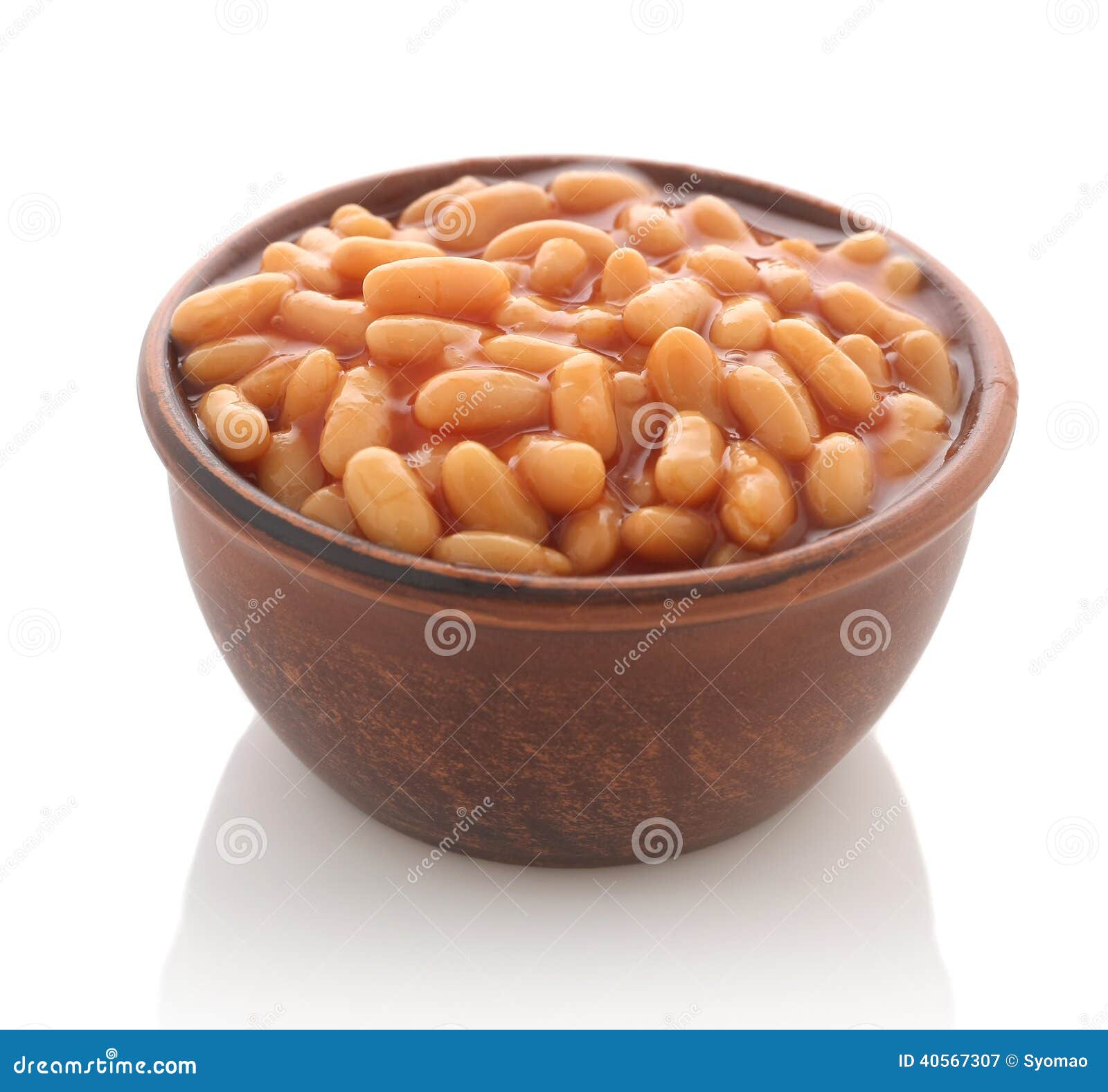cooked beans with red sauce in a clay bowl