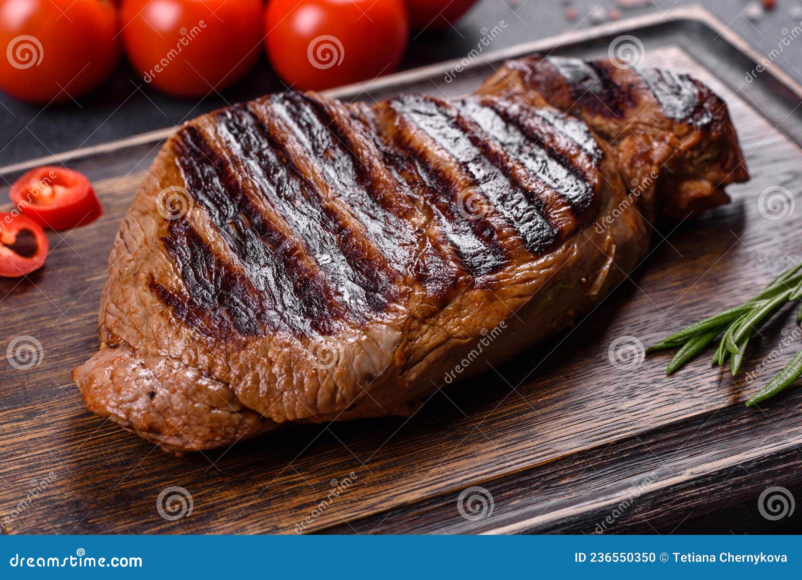 Cooked Grilled Chuck Eye Roll Steak on a Chopping Board Stock Photo