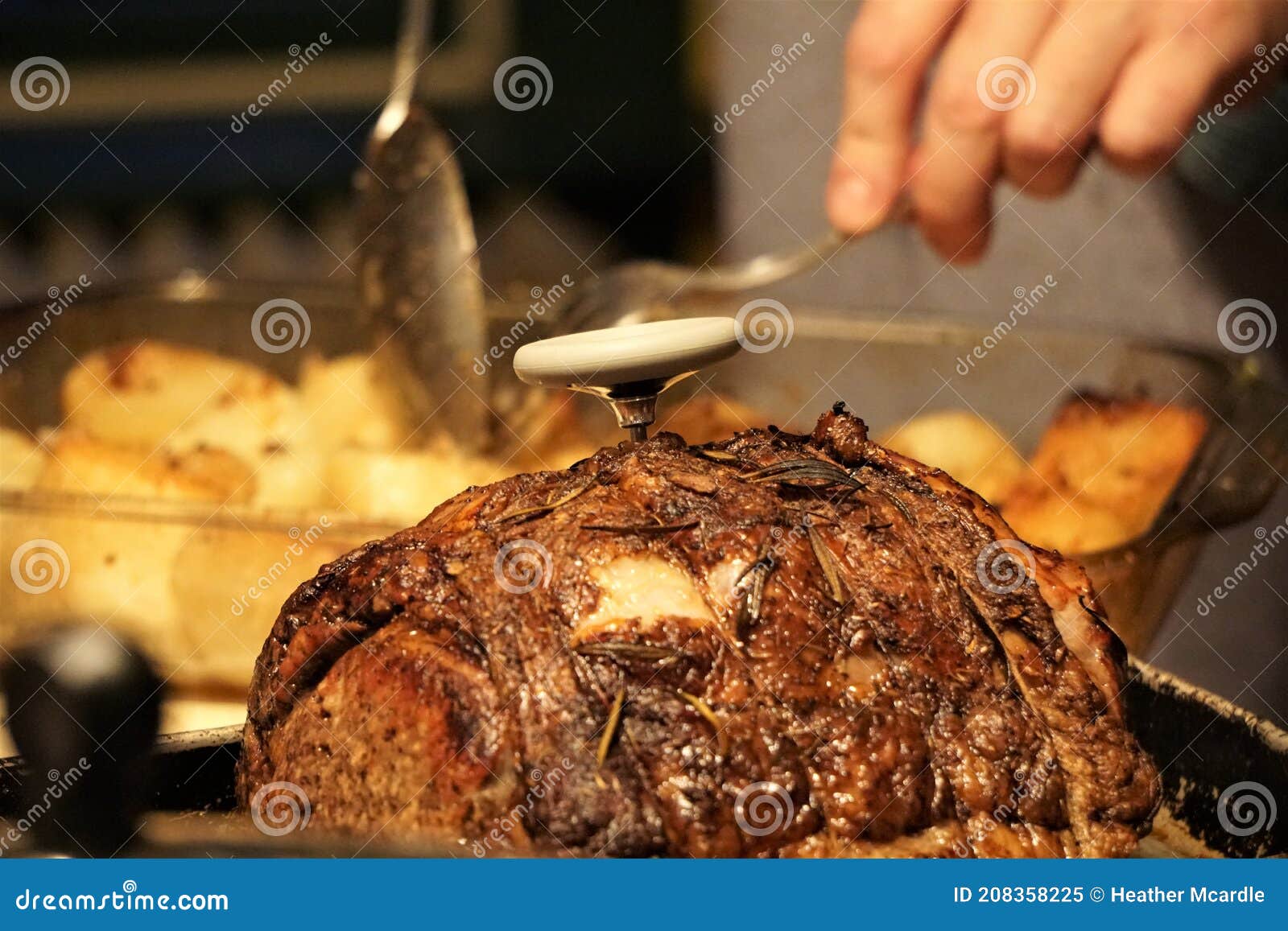 Using a meat thermometer to measure internal temperature of roasted beef  joint Stock Photo - Alamy
