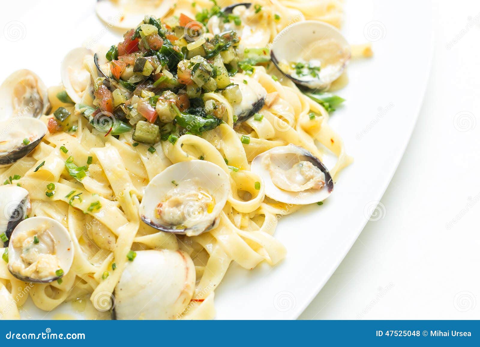 Cooked Pasta with Scallops and Mixed Vegetable Topping Stock Photo