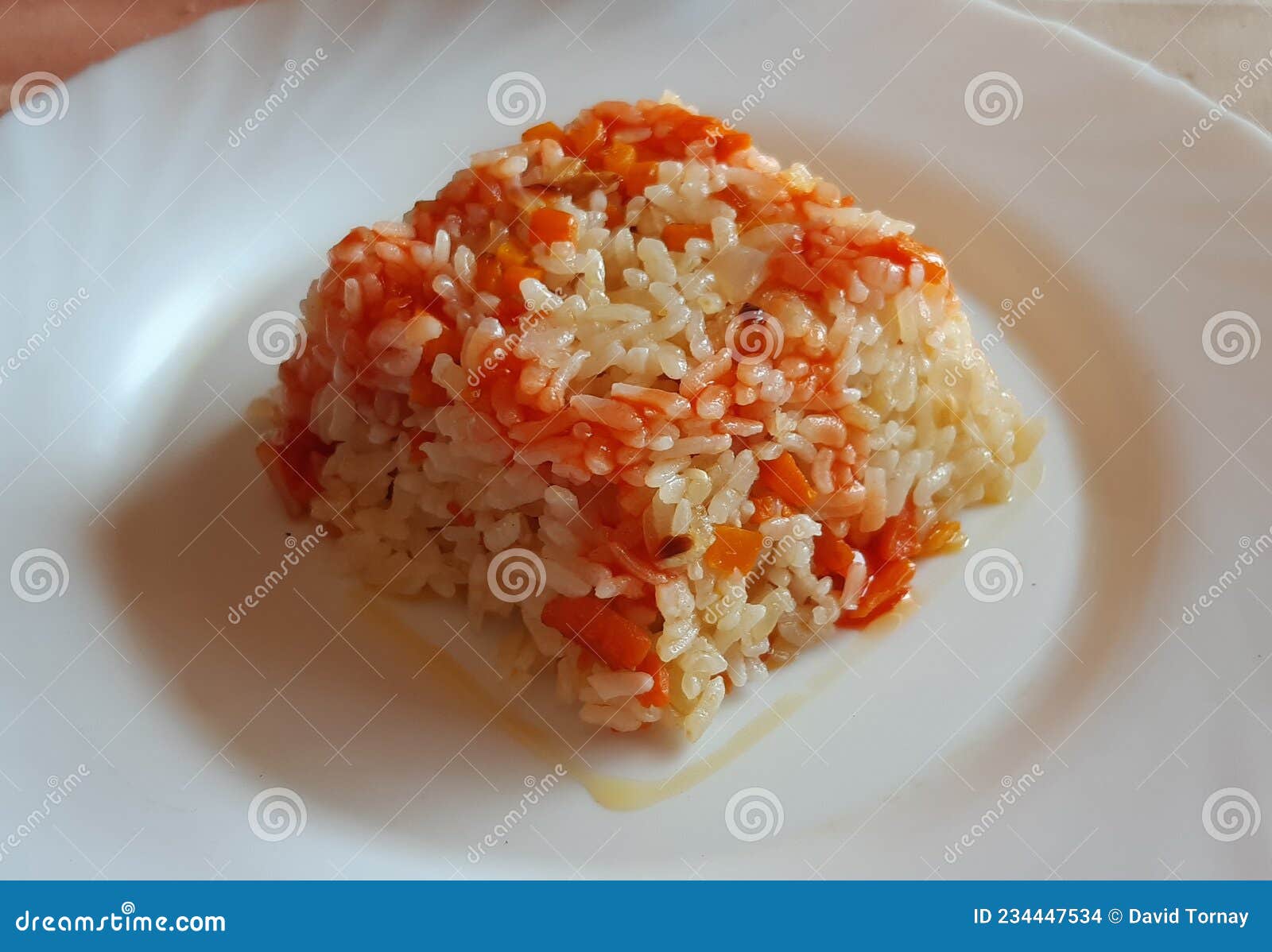 cooked rice with a little tomato sauce