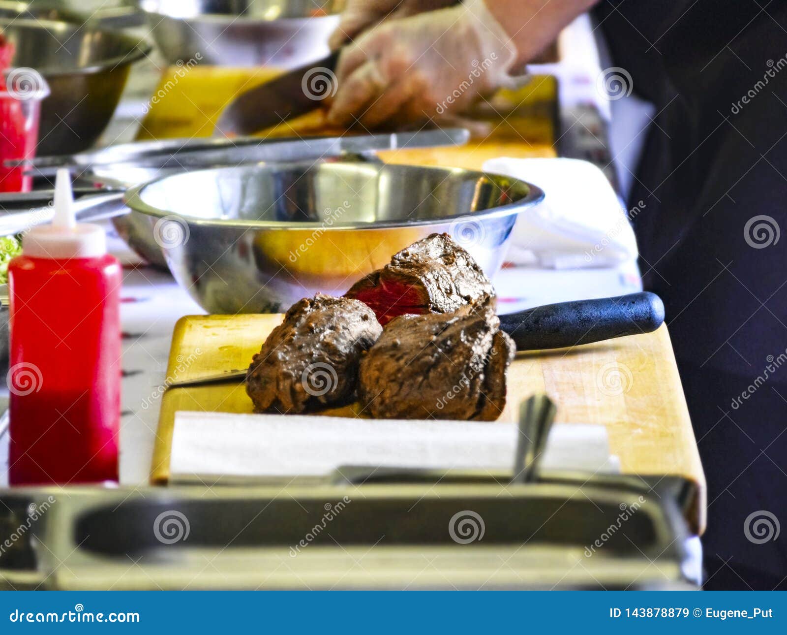 Cooked Roast Beef on a Cutting Board. Cooking Master Class, with People Learning How To