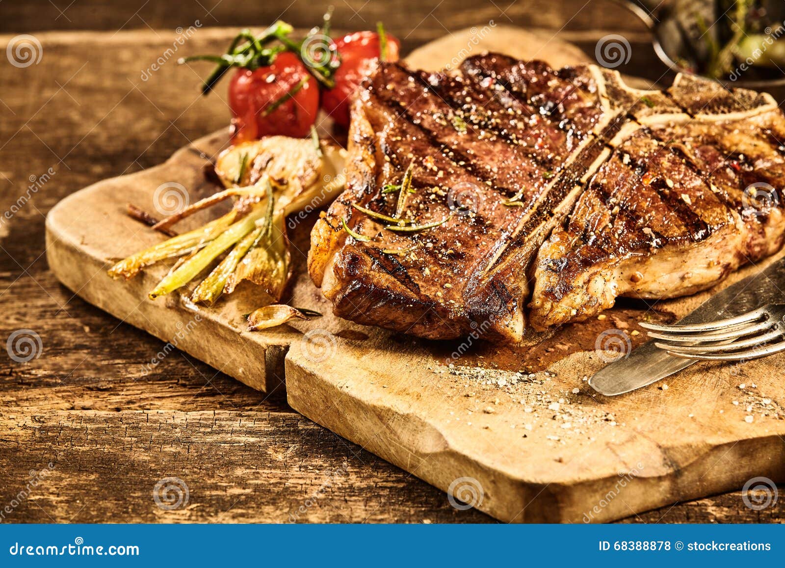 Cooked Tbone Steak with Roasted Garlic and Tomato Stock Photo Image of board, served 68388878