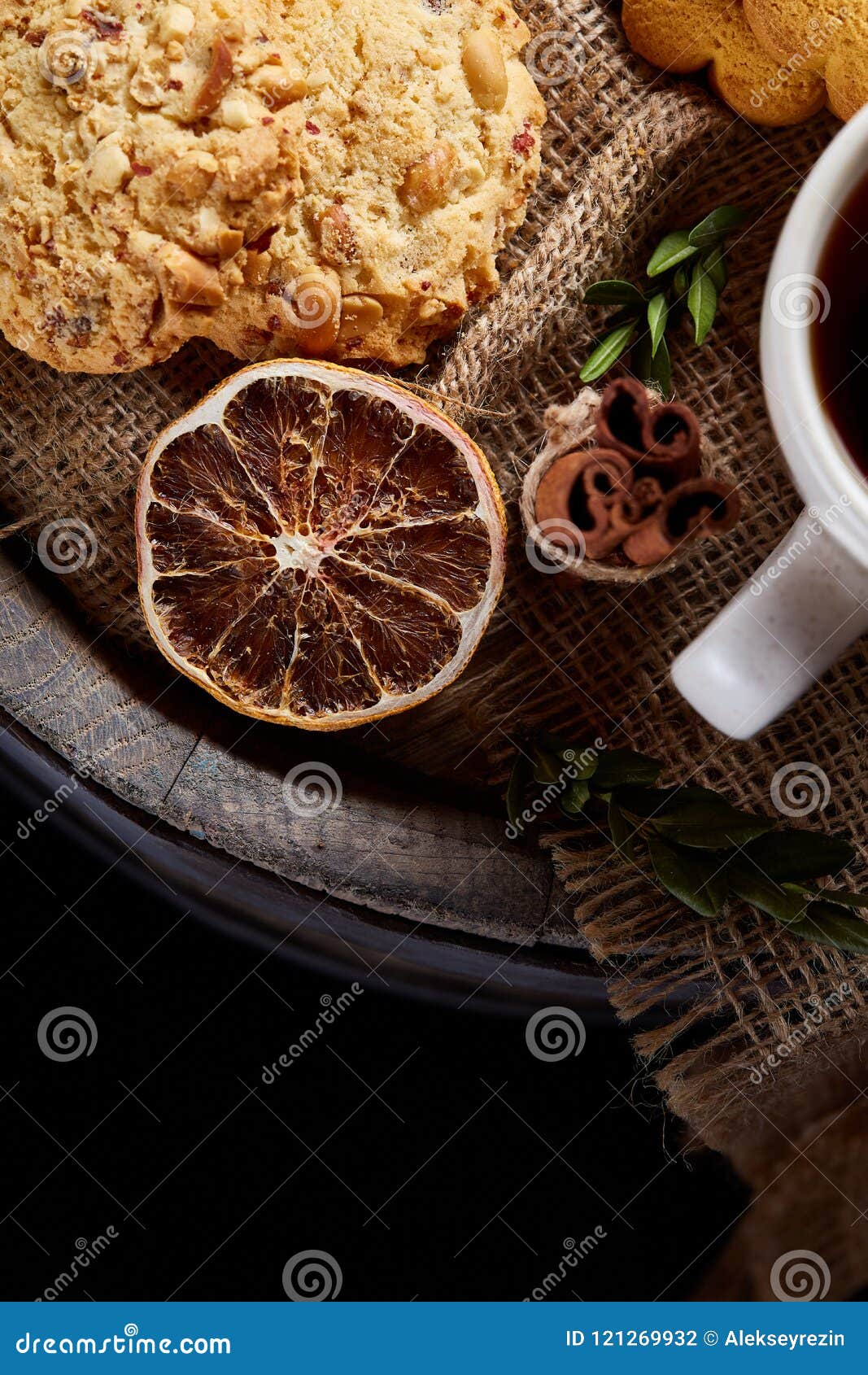 cookies with cinnamon and two cups of tea on a burlap napkin, selective focus, close-up, top view.