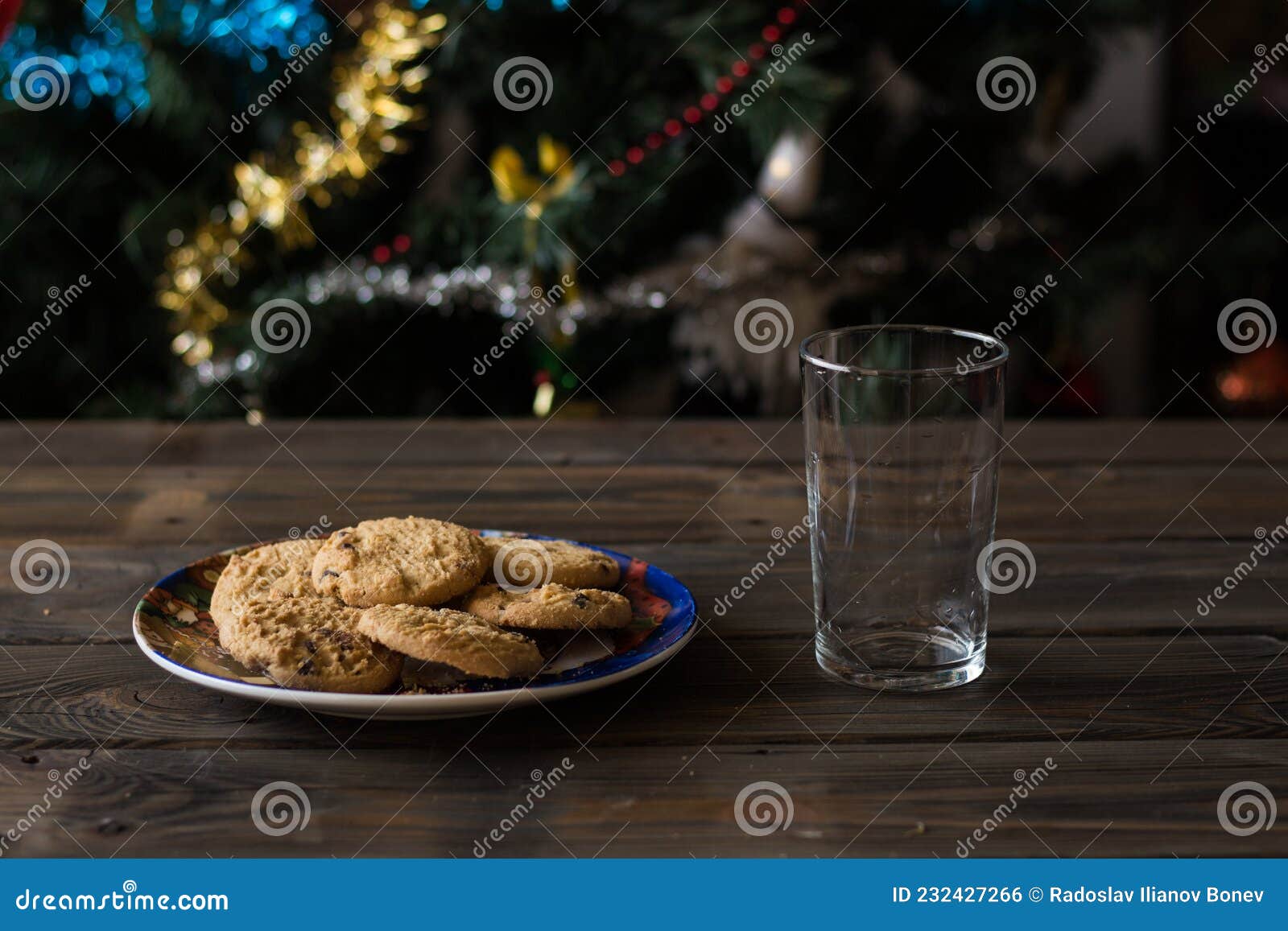 cookies and empty glass on a christmas tree background