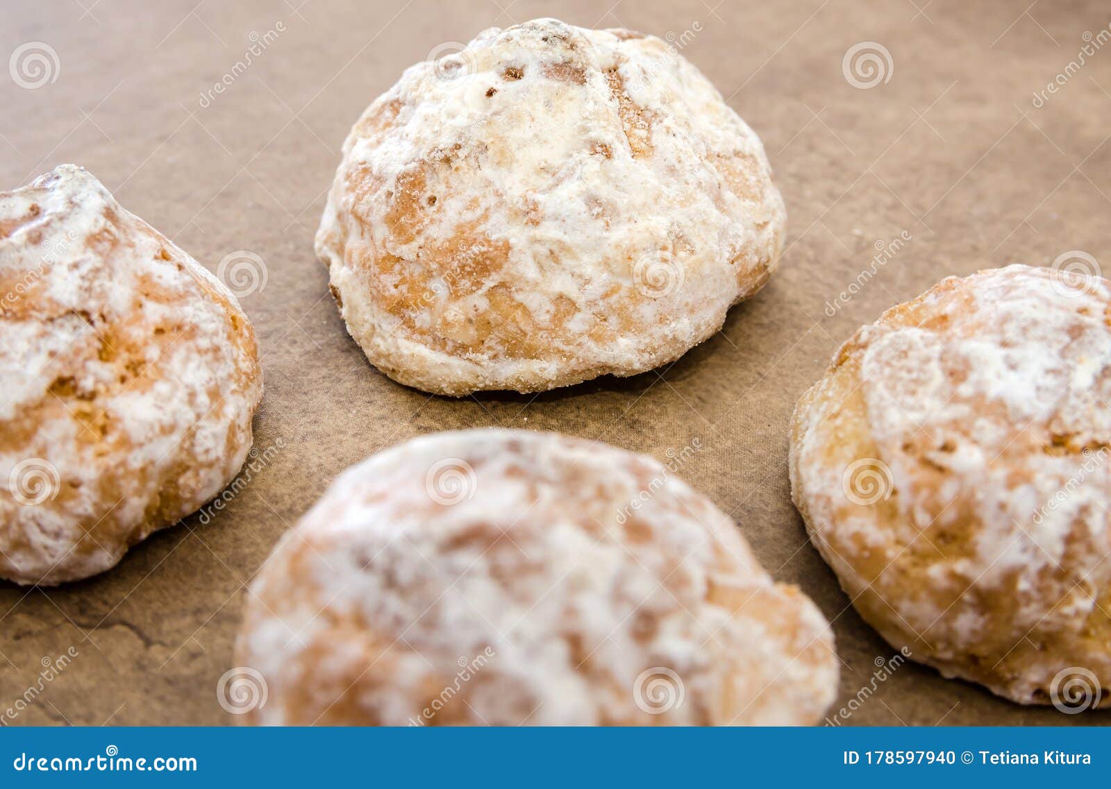 Cookies in White Icing with Apricot Jam Inside on a Wooden Table. Close